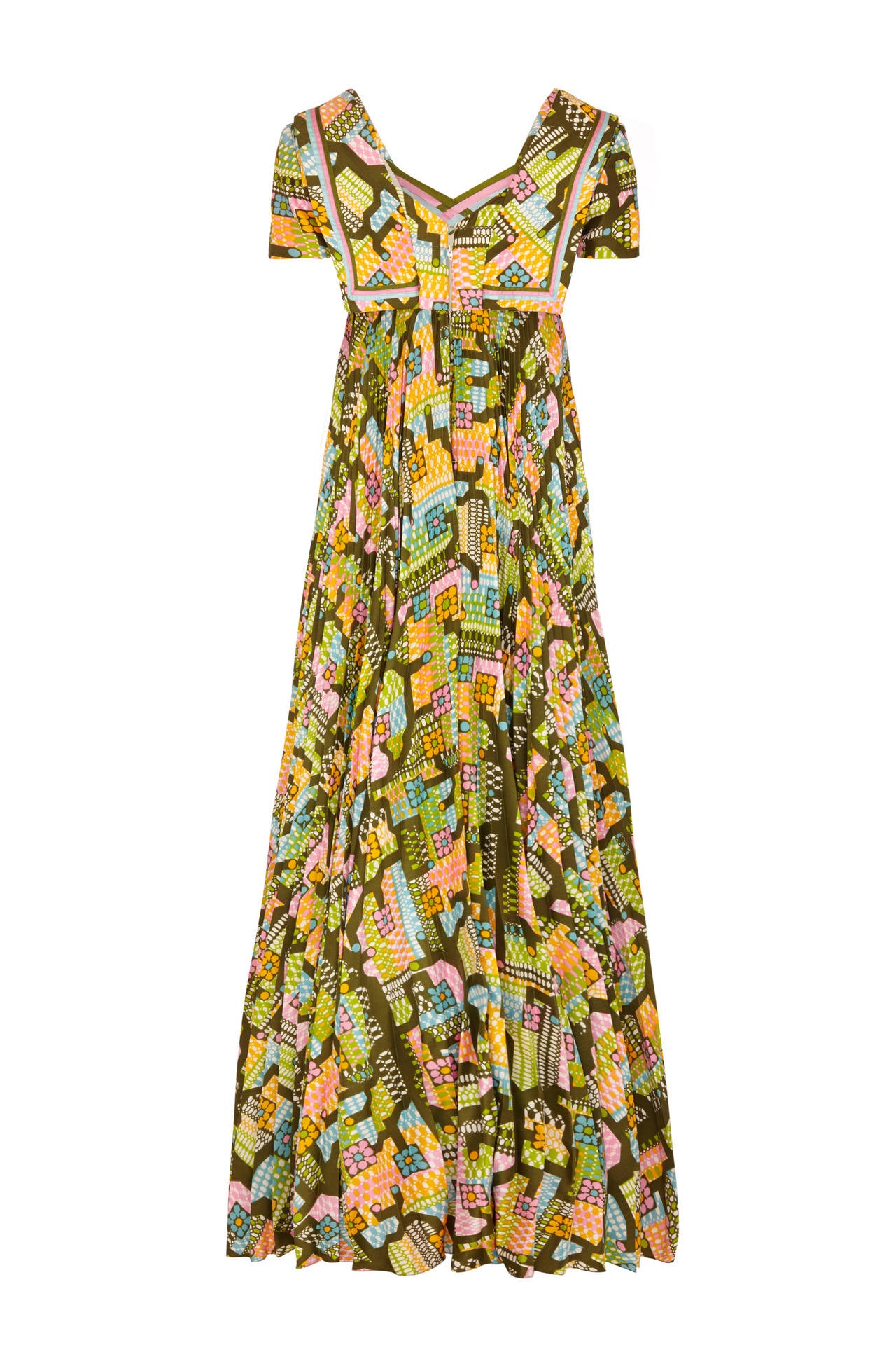 This 1970s abstract print silk empire line dress by iconic British designer Hardy Amies is in wonderful vintage condition and features a full length tightly pleated skirt, sailor collar and V-neckline with woven ribbon detail. Best renowned for his