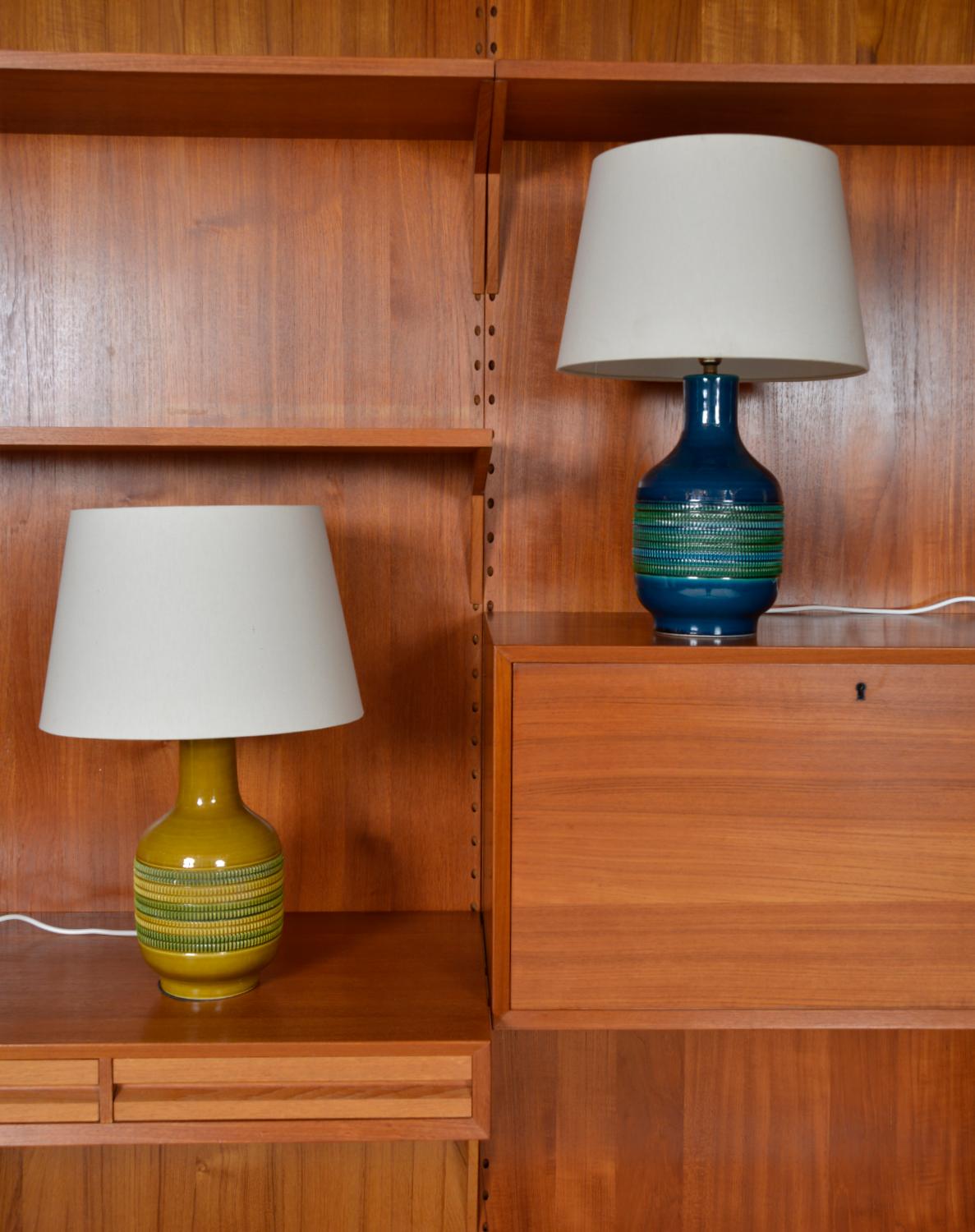A lovely colourful harlequin pair of 1970s Italian studio pottery lamps with raised pattern in mustard and green and navy blue and green - very much like Bitossi in the pattern and rimini blue colour. Both signed ‘Foreign’, the mustard lamp also