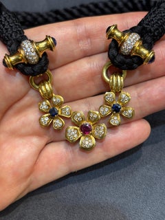 1970s Harry Winston 18k gold, ruby, sapphire and diamond choker on a black rope