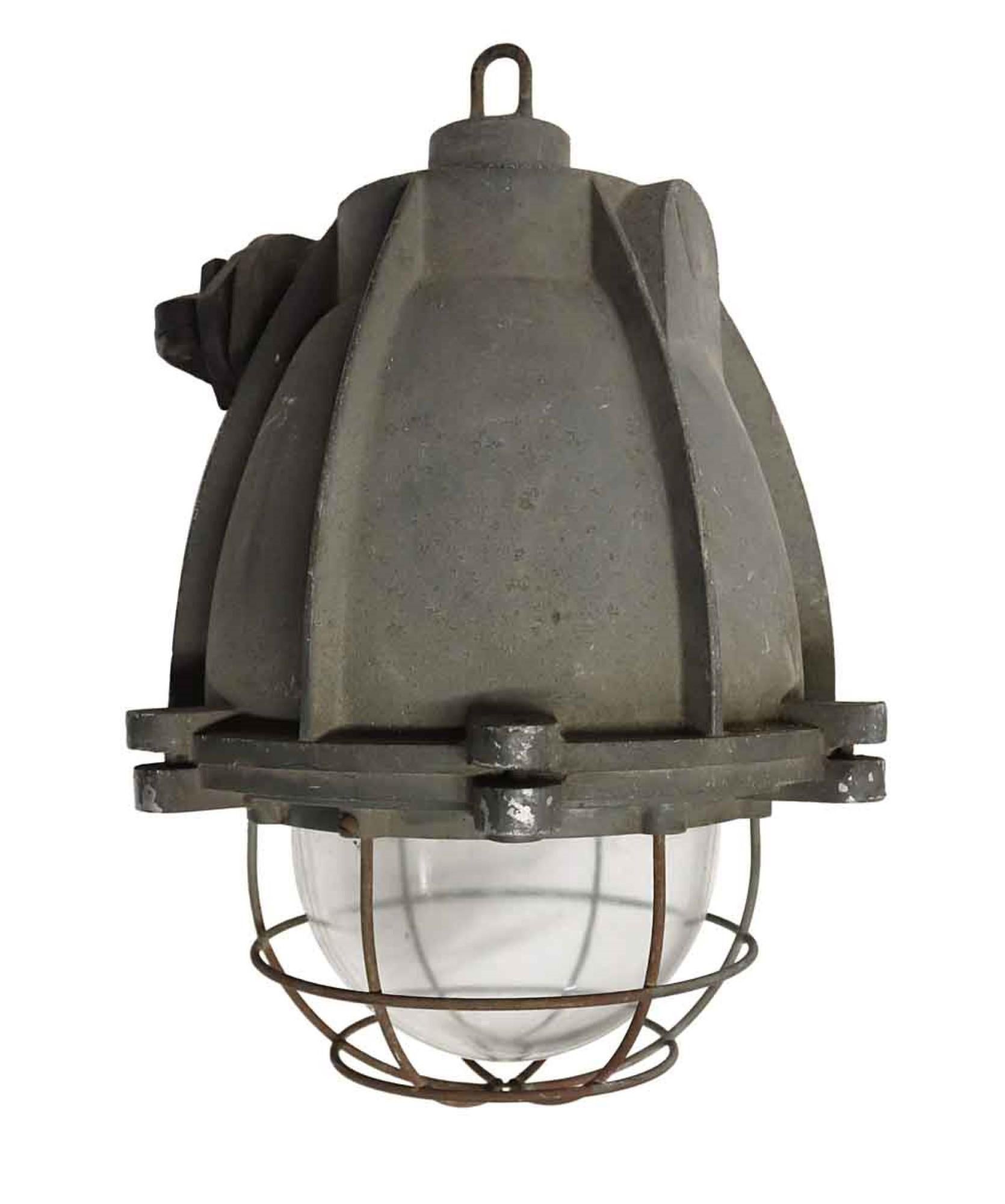 1970s vintage heavy cast aluminum light with cage covered glass. Industrial style pendant from Europe. Single socket. This can be seen at our 400 Gilligan St location in Scranton, PA