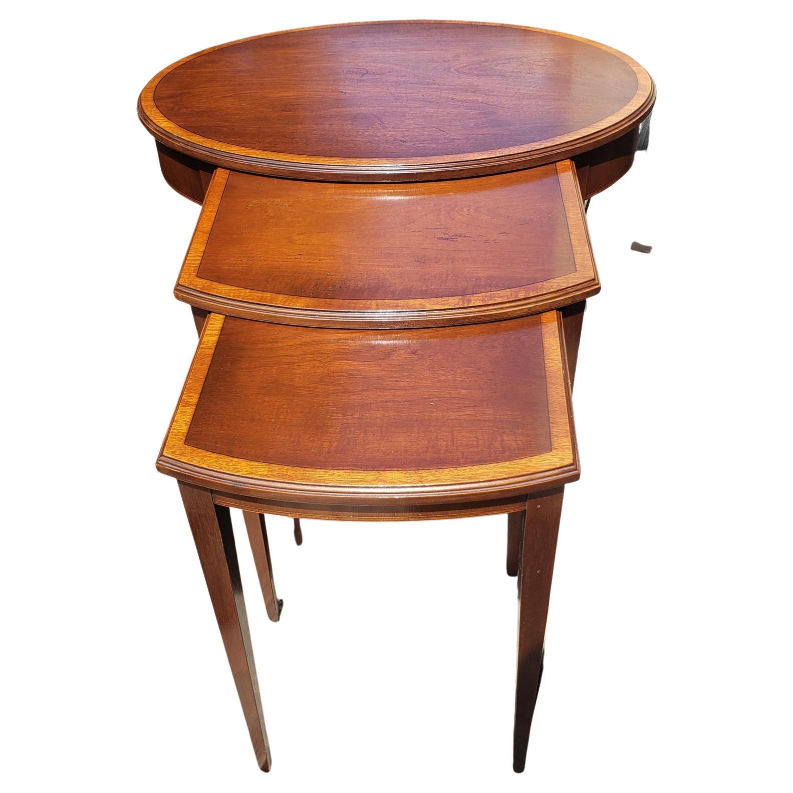Hekman Mid-Century Modern nesting tables. Walnut veneers on wood solids.

Manufacturer: Hekman Furniture
Collection: Mid Century Modern Occasional
Finish: Inlay / Mahogany

Large Table Dimensions: 
Width 26