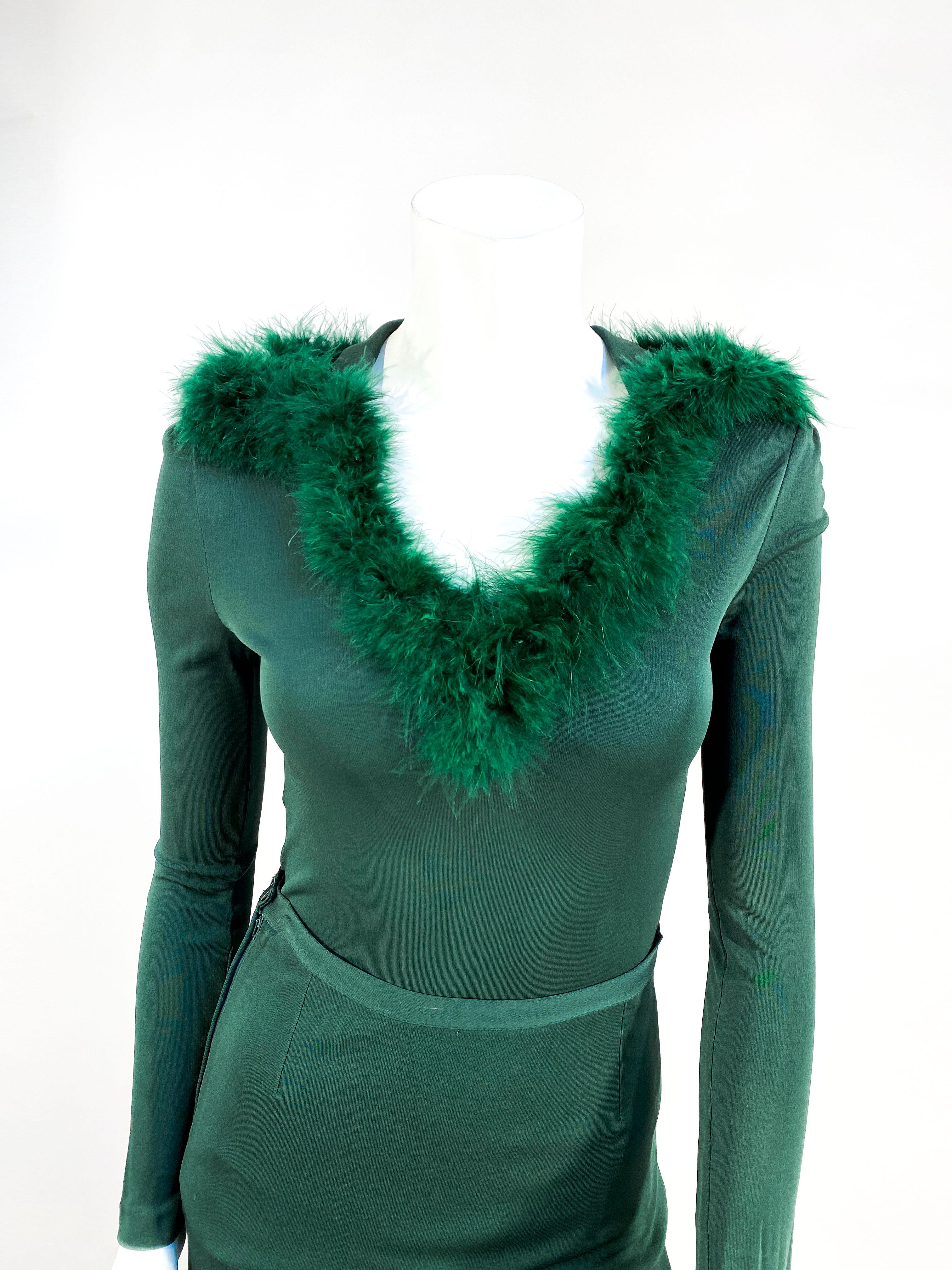 1970s Helga Howie forest green rayon kind two-piece set. The elongated tunic has long tapered sleeves, swan feather trim over na enlarged collar down to a moderately plunging neckline. The skirt has a was it band and is fitted to the hip to where it