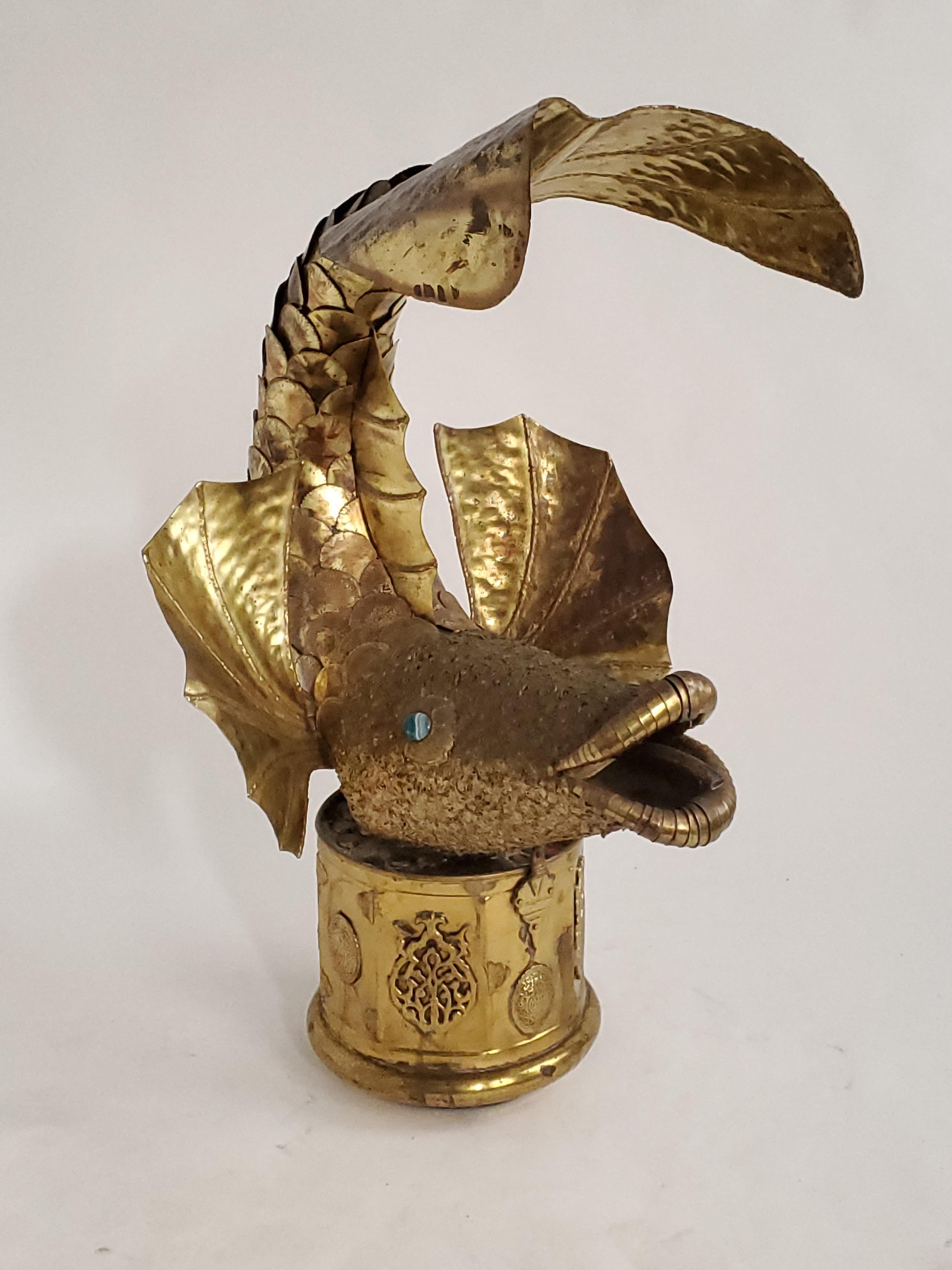 Fish sculpture, made of torch cutted, hand hammered and welded brass structure sitting on a oriental style brass base filled with ciment.

All his fountains sculpture are unique but this one really stand out with is tail  curling over its head ,