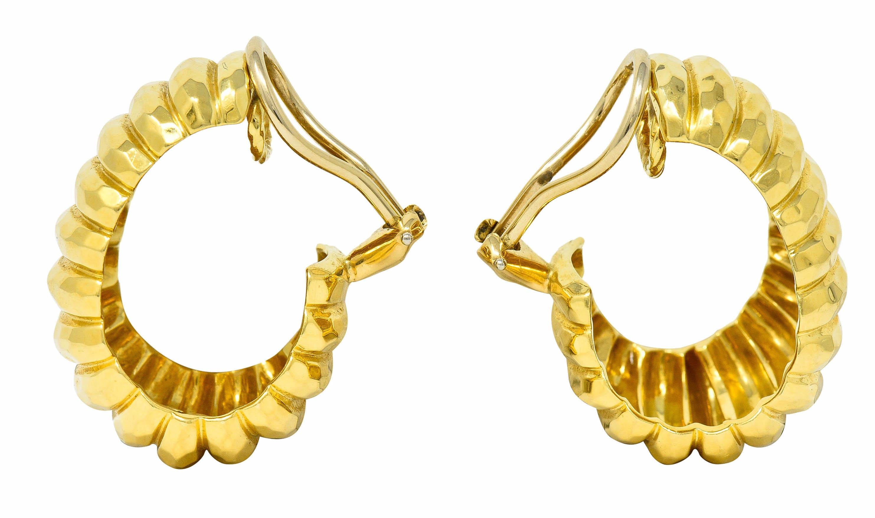 J hoop earrings are deeply ridged with a brightly polished and faceted finish

Completed by hinged omega back earrings

Stamped 18K and 750 for 18 karat gold

Numbered, signed Dunay, and with maker's mark for Henry Dunay

From the vintage Cynnabar