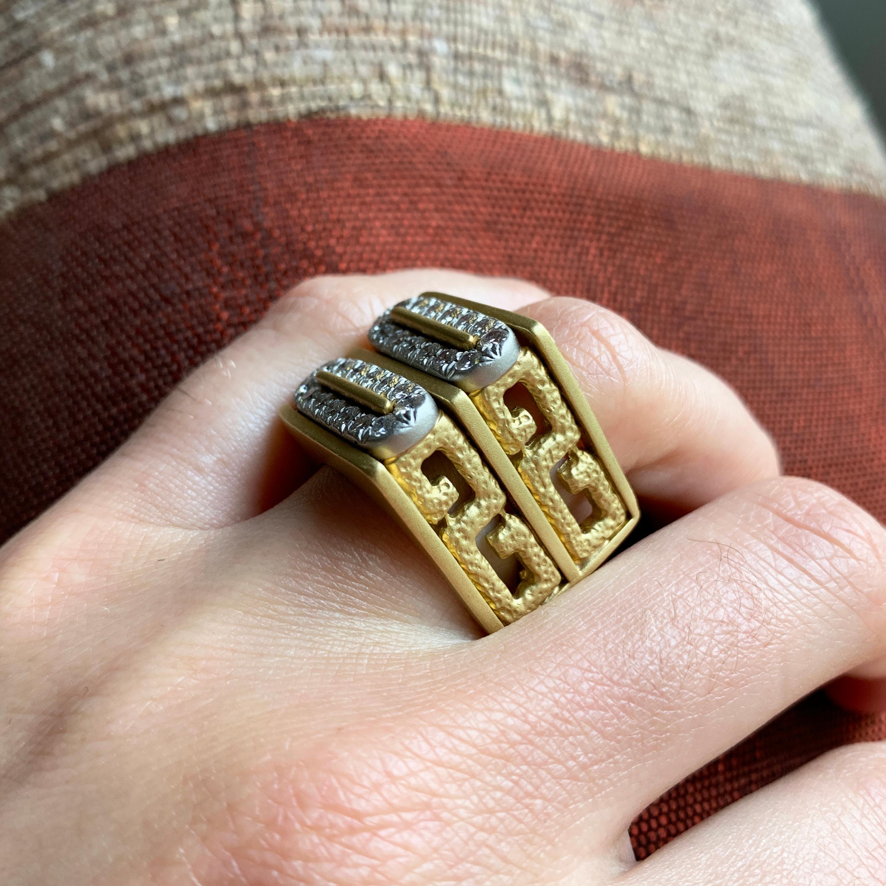 A diamond and 18 karat gold square shank ring, by Henry Dunay, c. 1975.

Diamond weight is approximately 1.15 ctw. The ring is a size 6 and signed Dunay 18k. 

Due to the nature of the design this ring can not be sized up. 