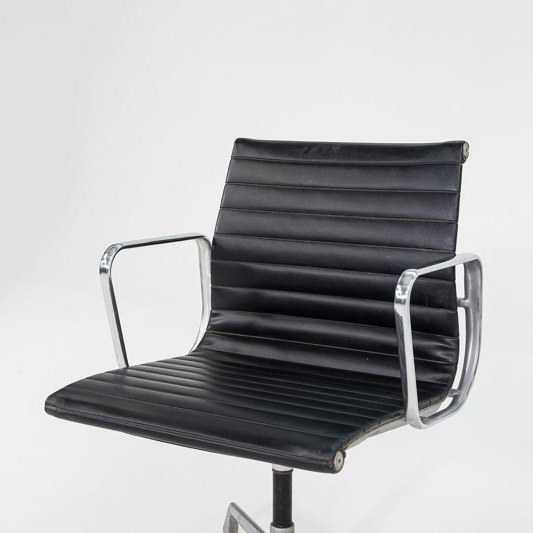 These are Eames Aluminum Group Desk Chairs, Model EA308, initially designed by Ray and Charles Eames for Herman Miller in 1958. These particular chairs were manufactured in the 1970s. The design features a lightweight aluminum frame with a 4-star