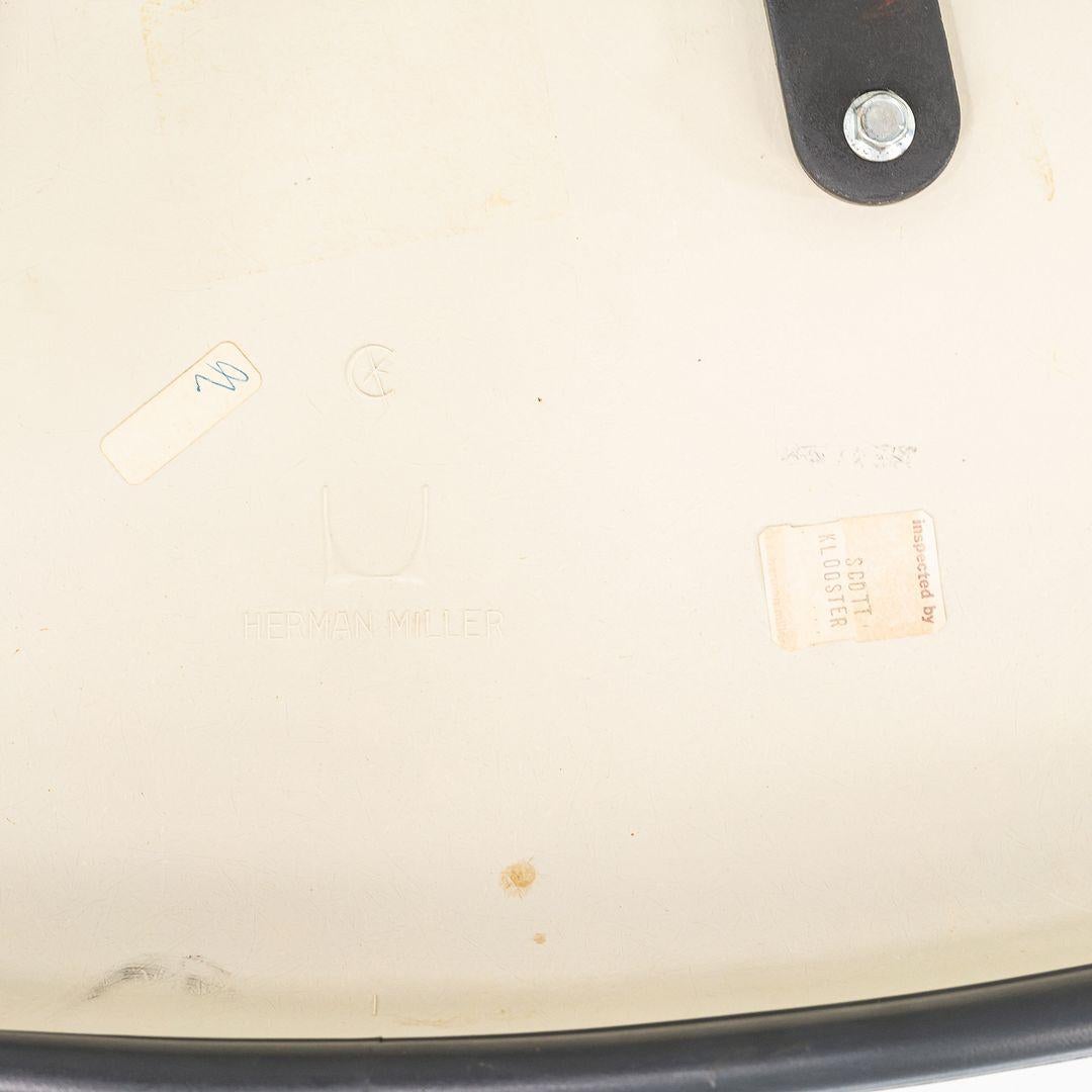 This is an Eames Arm Shell Chair, Model EC434, originally designed by Ray and Charles Eames in the 1970s. This particular example was produced by Herman Miller in the USA in the 1970s. The design of this piece features a molded fiberglass shell with