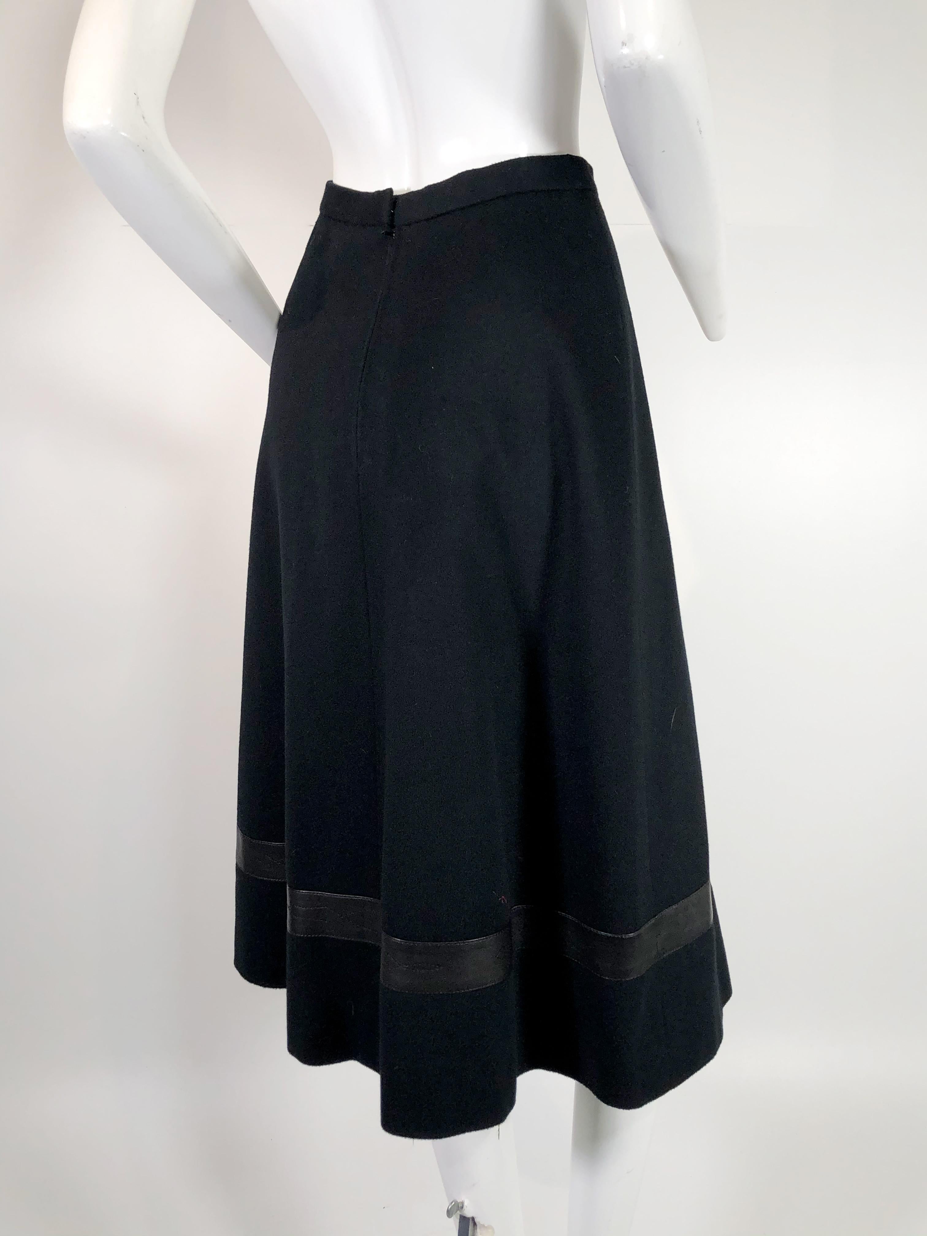 A luxurious 1970s Hermes cashmere woven and flared skirt with western-inspired stitched leather band at knee. 