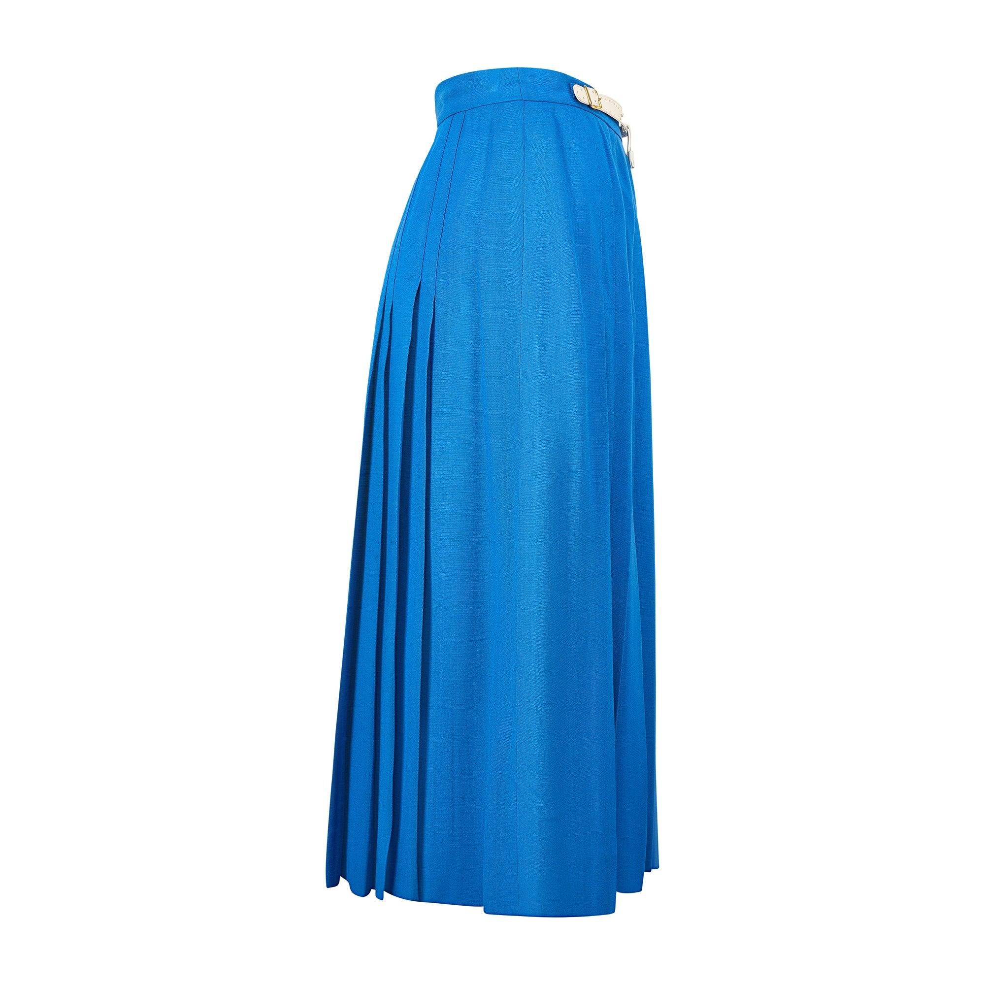 This vibrant skirt was designed by Hermès during the late 1970s to early 1980s. Crafted from high quality viscose, it has a bold French blue hue that makes it an ideal summer wear. The skirt is box pleated and falls to the mid-calf. The waistband