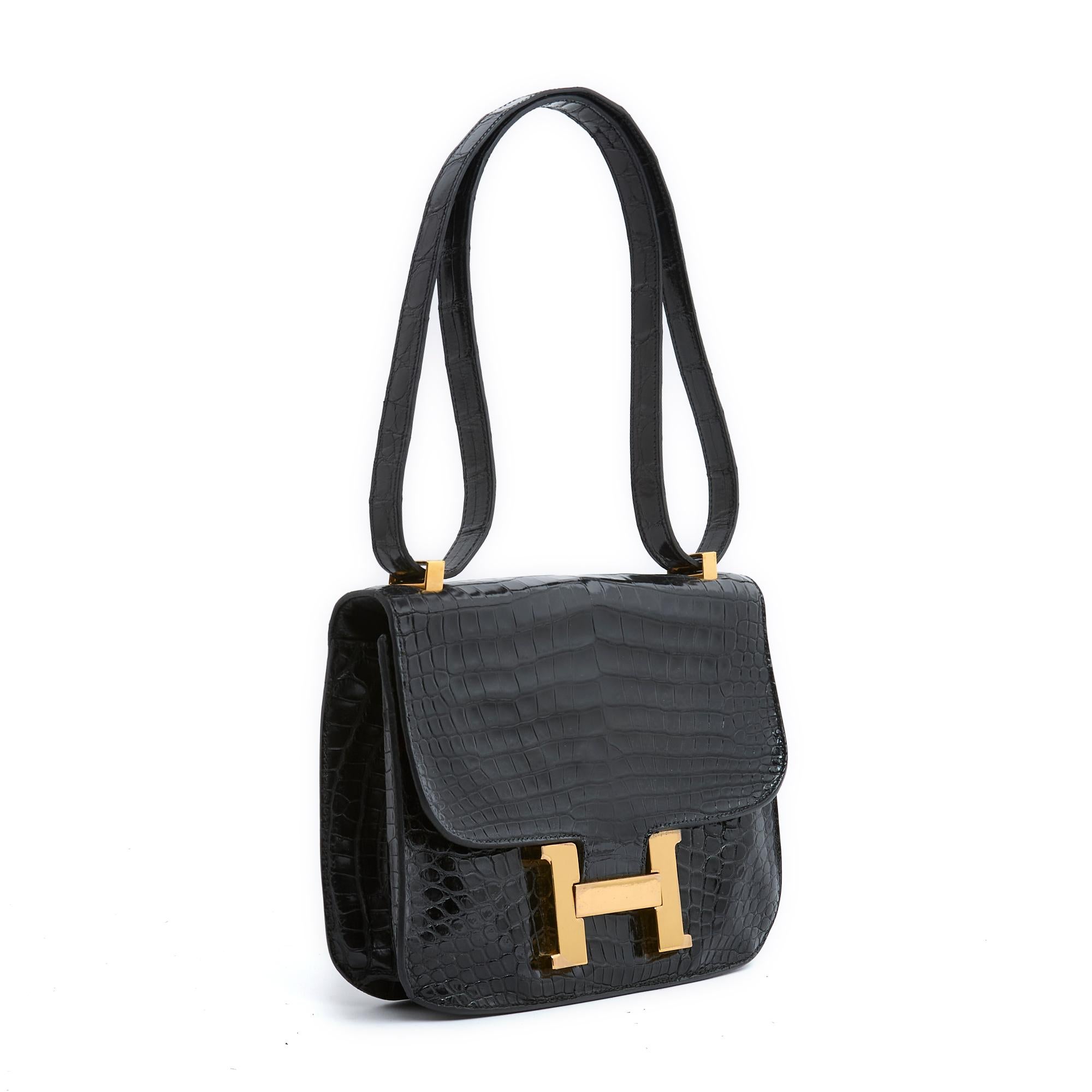 Hermès Constance model bag in black exotic leather (Porosus), interior in soft black leather with one patch pocket and one zipped pocket, clasp with the famous H motif in gold metal (brass), shoulder strap for single (shoulder) or double carry