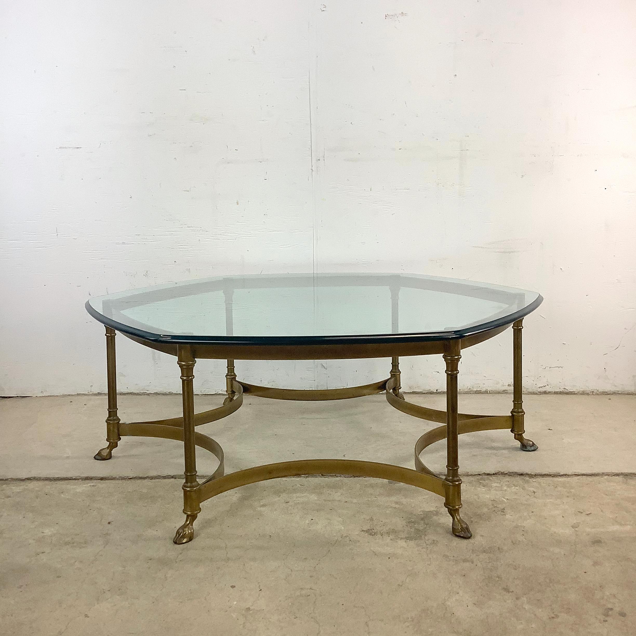 This vintage hexagonal coffee table embodies the essence of Maison Jansen-inspired style: clean lines, rich materials, and unexpected detail. Featuring a brass frame with a beveled-edge glass top and figural hoof feet, it’s a showpiece that exudes