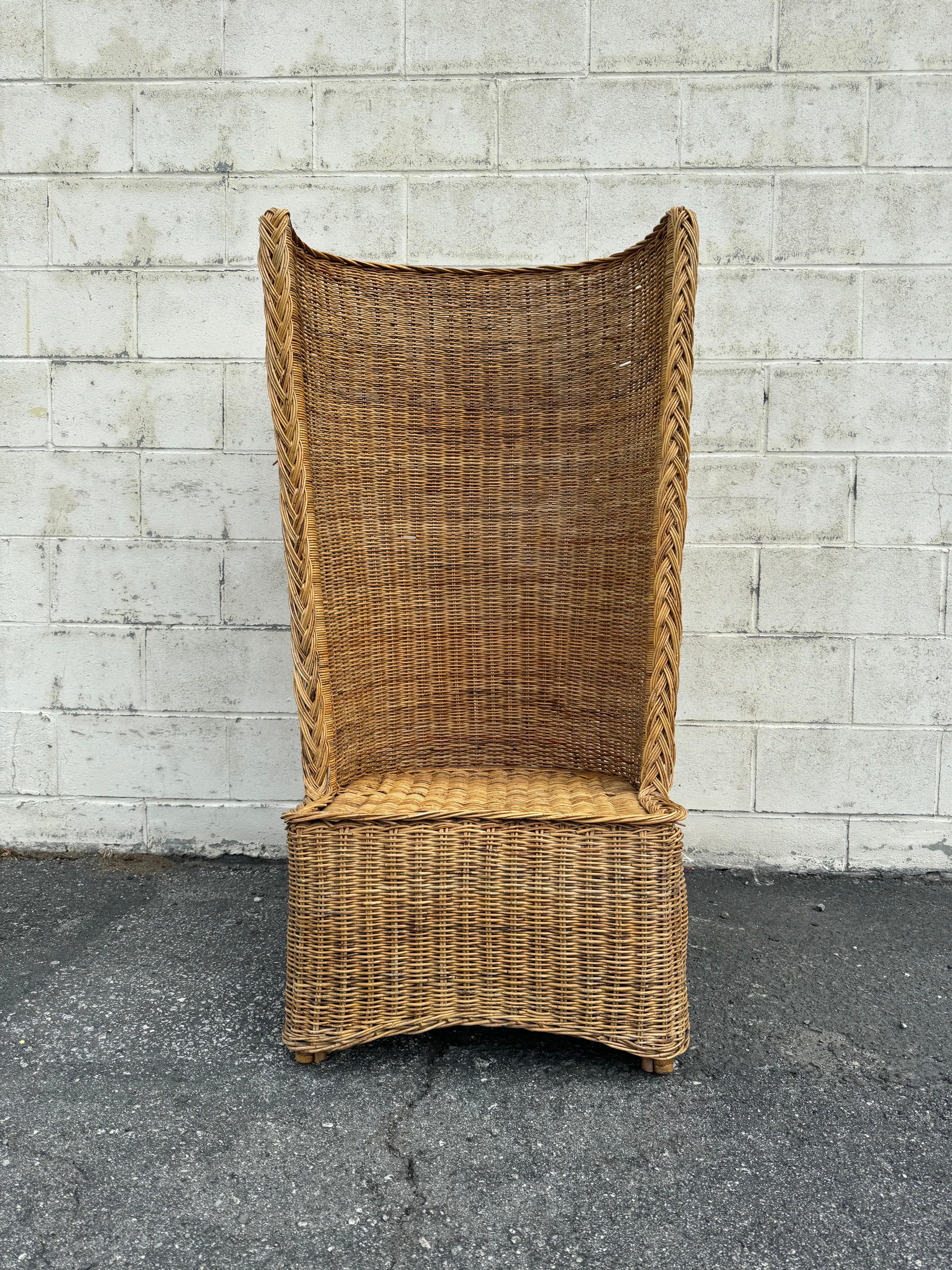 Very cool and boho chic rattan woven wicker chair. This one of a kind rattan chair comes with a unique high barrel back and comfortable seat. The chair sits on a bamboo frame for strength.

This chair is in excellent structural condition. It is