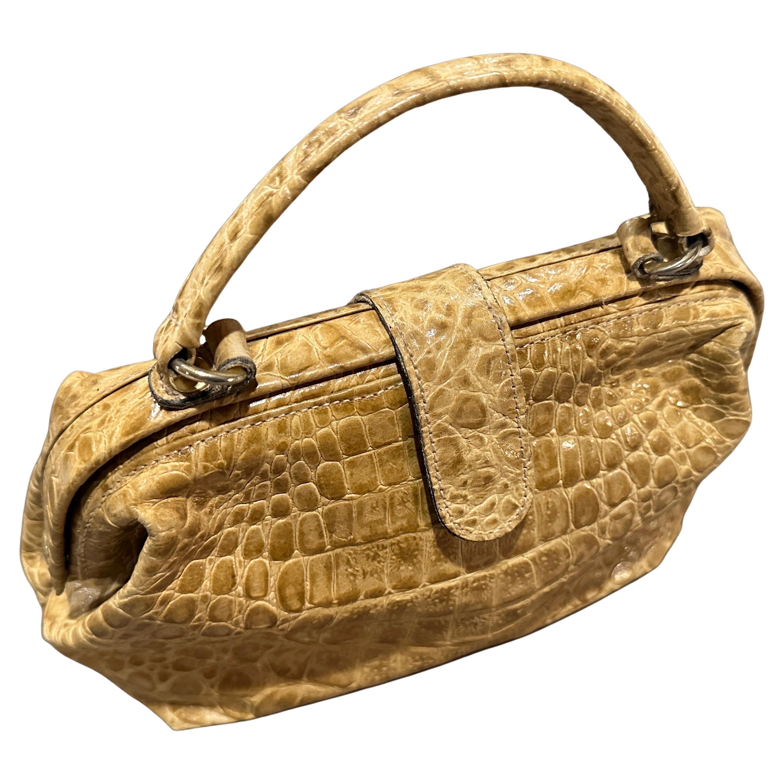 1970s High-Quality Italian Light Brown Embossed Leather Top Handle Bag
Discover the exquisite craftsmanship of Italian design with this elegant 1970s top handle bag. This sophisticated accessory is a testament to the era's focus on luxurious
