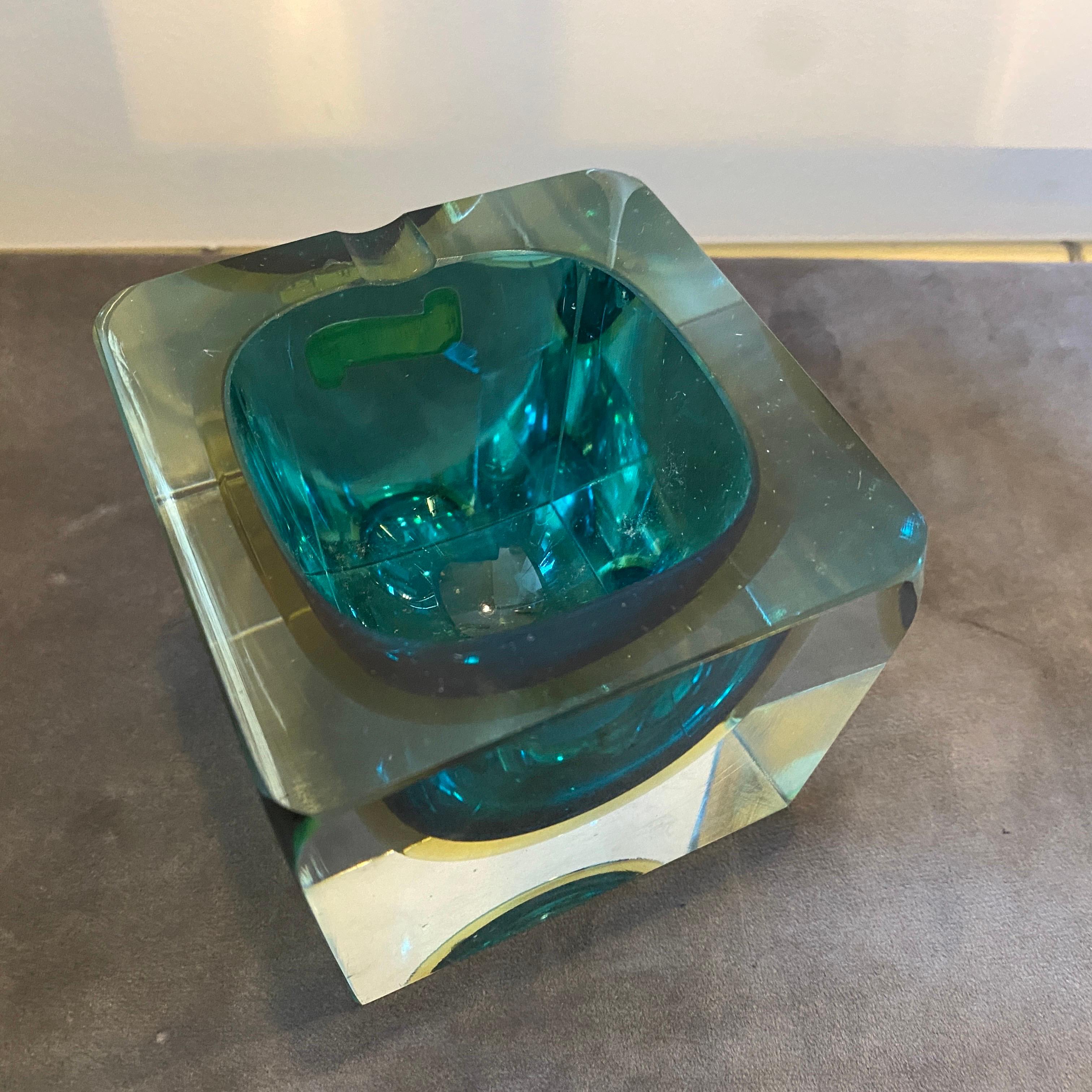 A stylish green and yellow sommerso murano glass ashtray designed and manufactured in Italy in the Seventies by Mandruzzato. It's in perfect conditions.