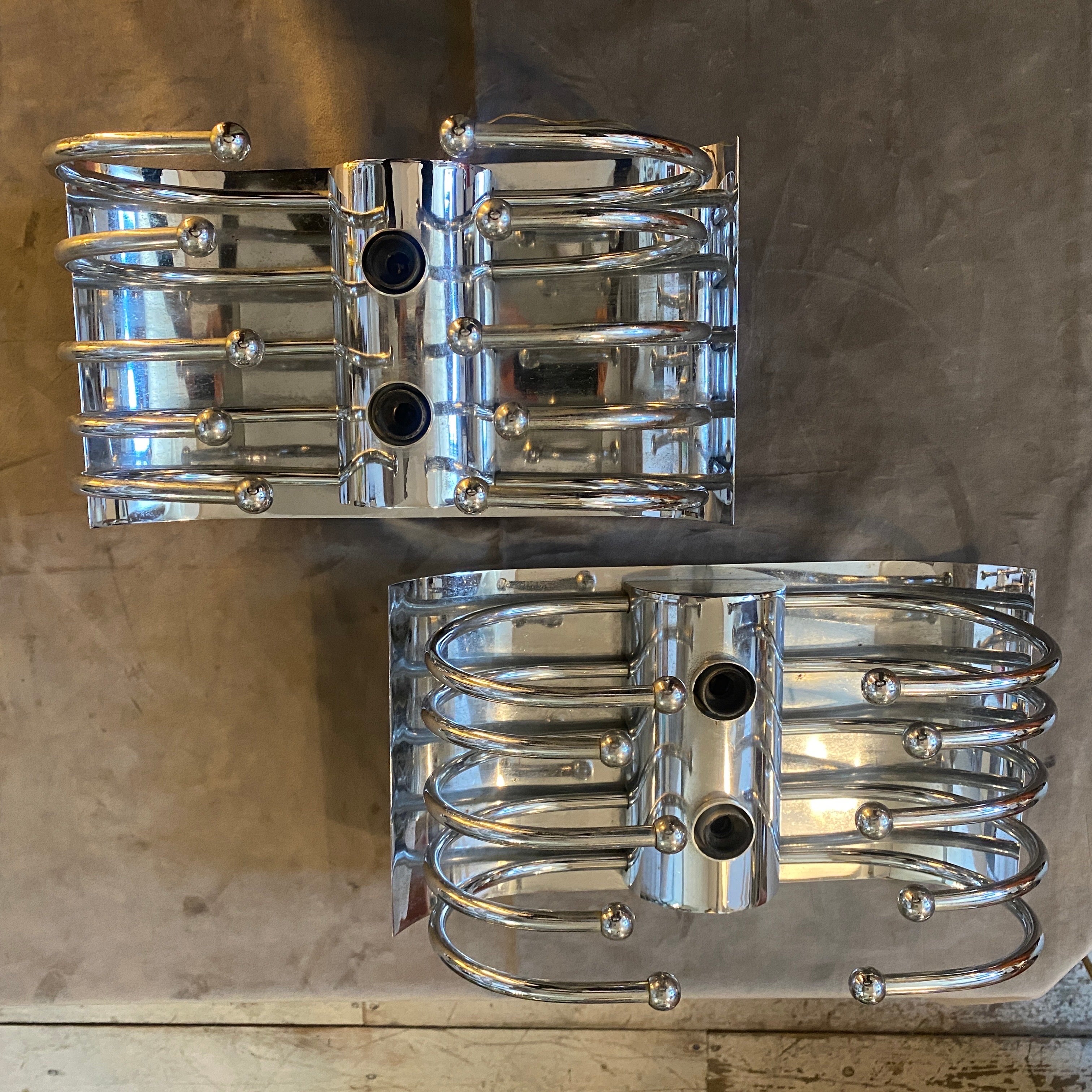 Two chromed metal wall sconces designed and manufactured in Italy in the Space Age era inspired by the pistillo sconces of Studio Tetrarch that were a popular design in the 1960s and 1970s, featuring a distinctive bulbous shape and made of glass and