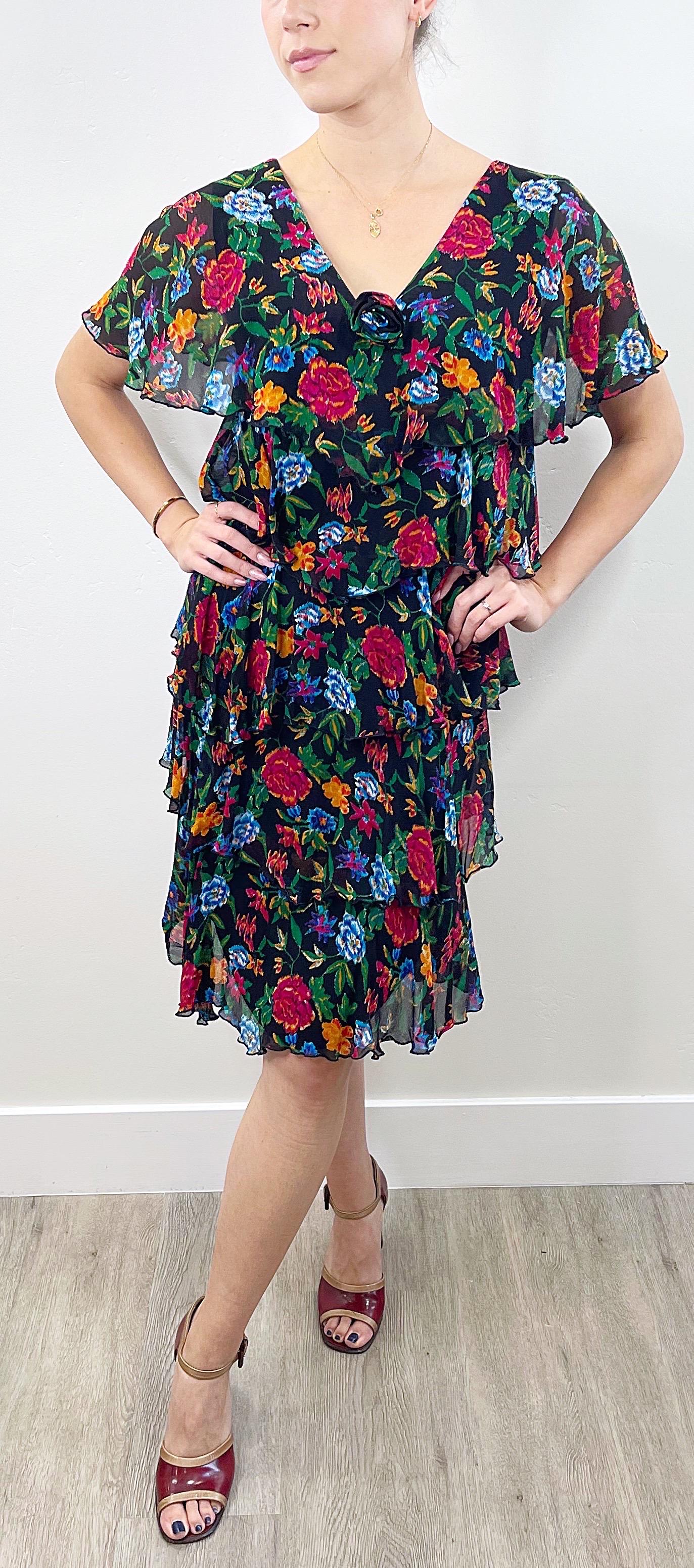 Chic late 70s HOLLY’S HARP silk chiffon colorful floral print tiered dress ! Features a black background with vibrant colors of green, blue, pink, orange and red throughout. Simply slips over the head. Perfect for any day or evening event. Pair with