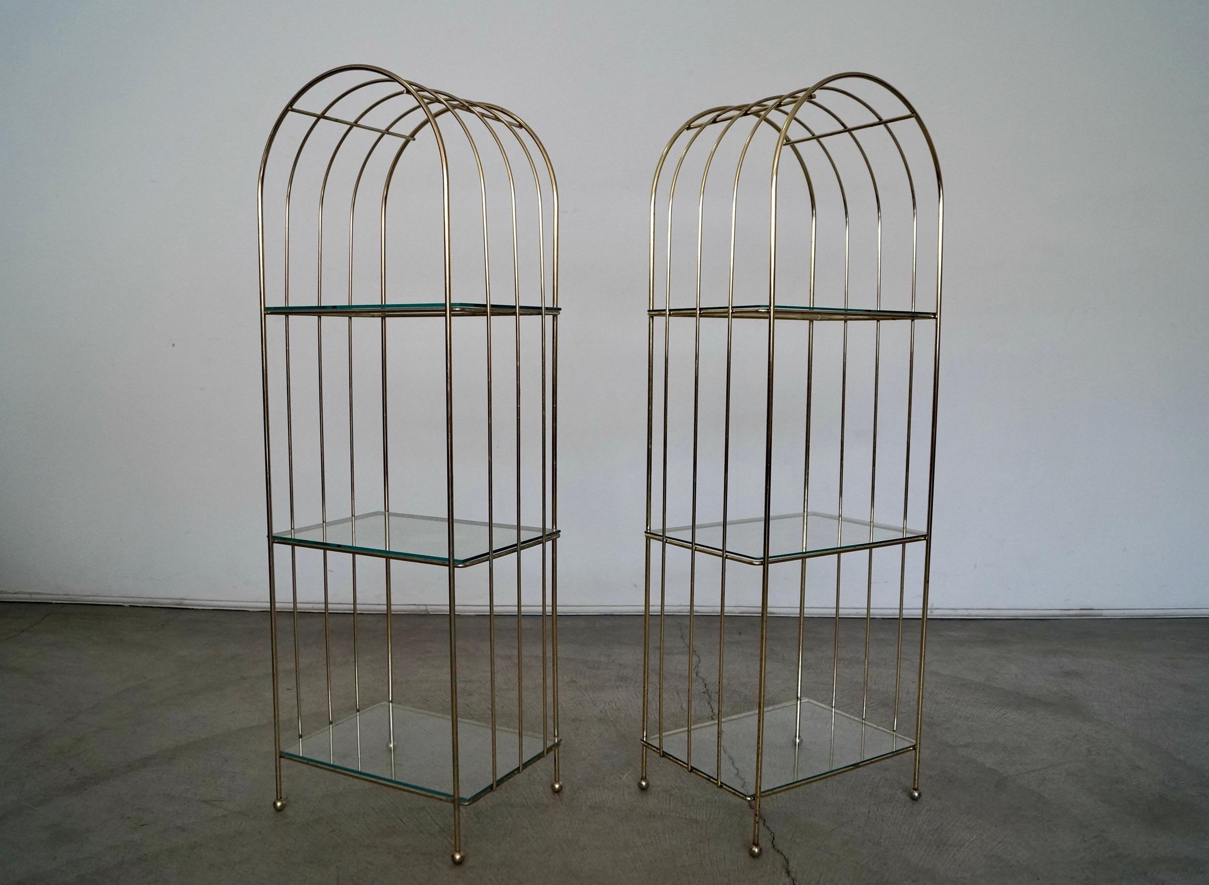 Pair of vintage Mid-Century Modern brass shelving units for sale. From the 1970's, and a beautiful Art Deco arching design in brass. Has three shelves each etagere, and can be used as a shelf or an accent piece for the bathroom for towels and the