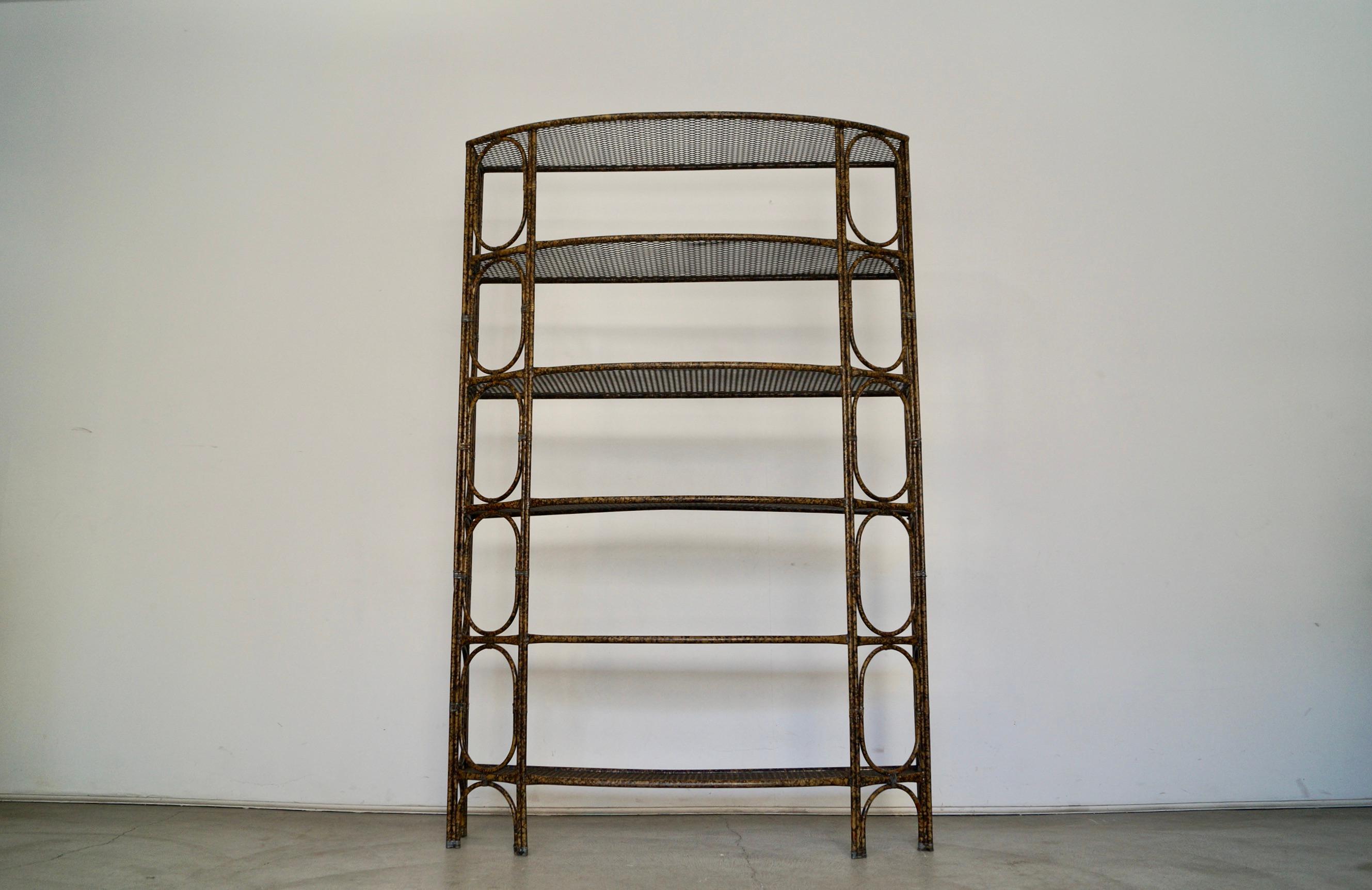 Vintage 1970s Hollywood Regency metal shelf for sale. Very unique designer shelf with a very unique finish. It's made of metal with a rattan design and perforated metal shelves. It has six shelves, and can be used as a divider or etagere. The color