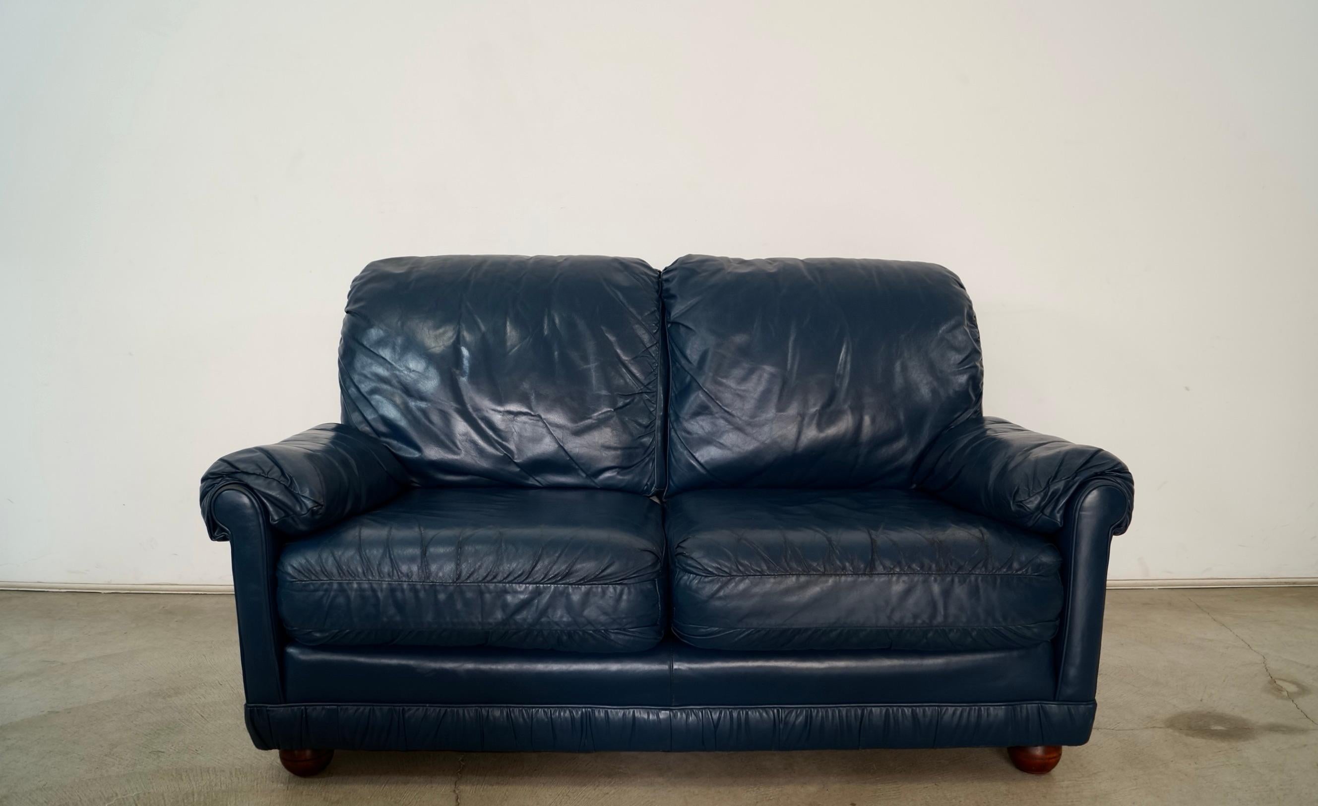 Vintage 1970's couch for sale. It was manufactured by Classic Leather here in the US, and still has the original foil label. It was made with genuine top grain leather, and shows beautiful vintage patina to the leather. It's a nice classic navy blue