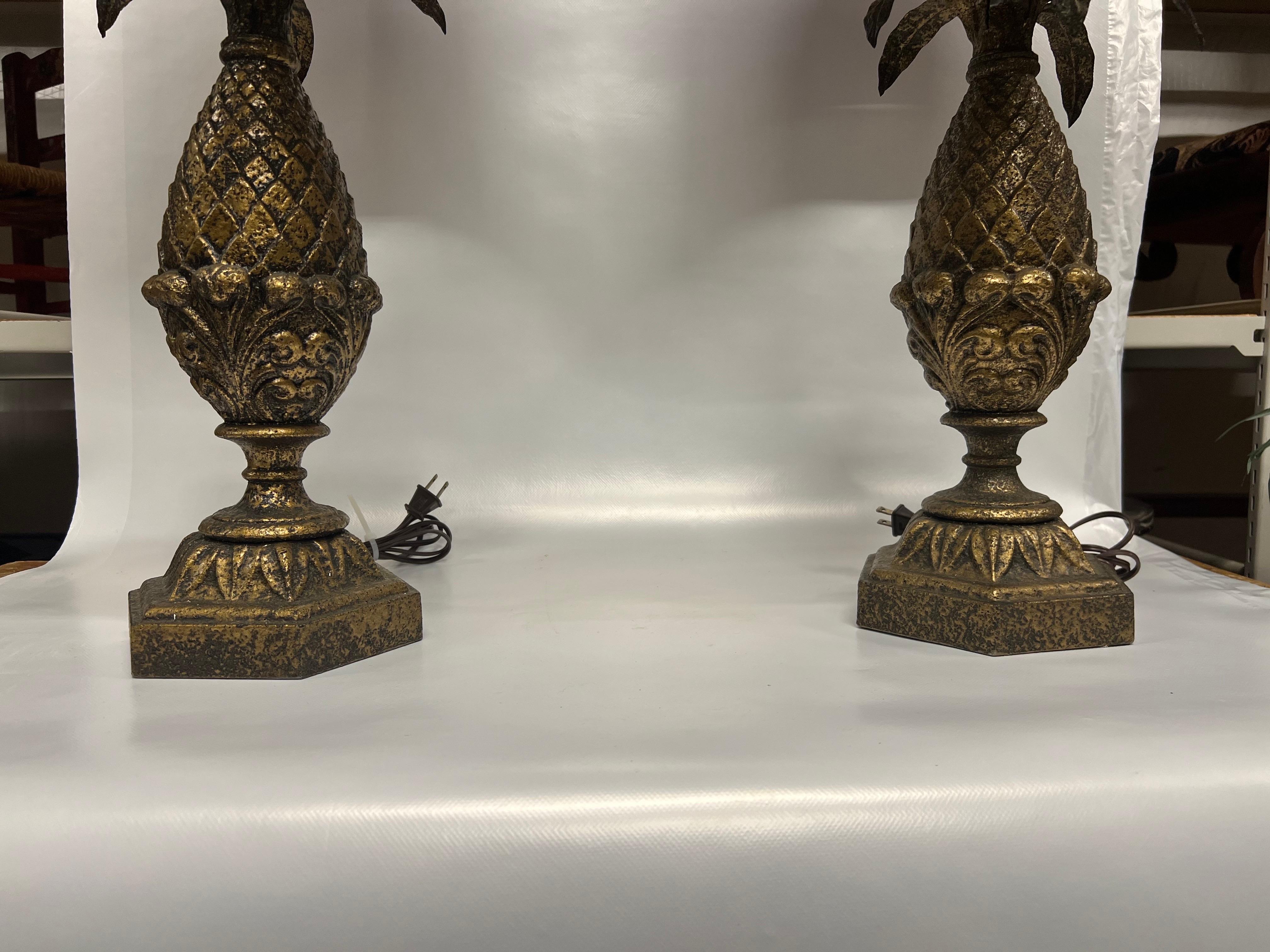 Una fantastica coppia di lampade da tavolo in resina con foglie in metallo.  Queste vengono fornite con il terminale abbinato e un paralume bordeaux con sfumature dorate all'interno per abbinarsi alle lampade color ottone.   Stile Hollywood Regency.