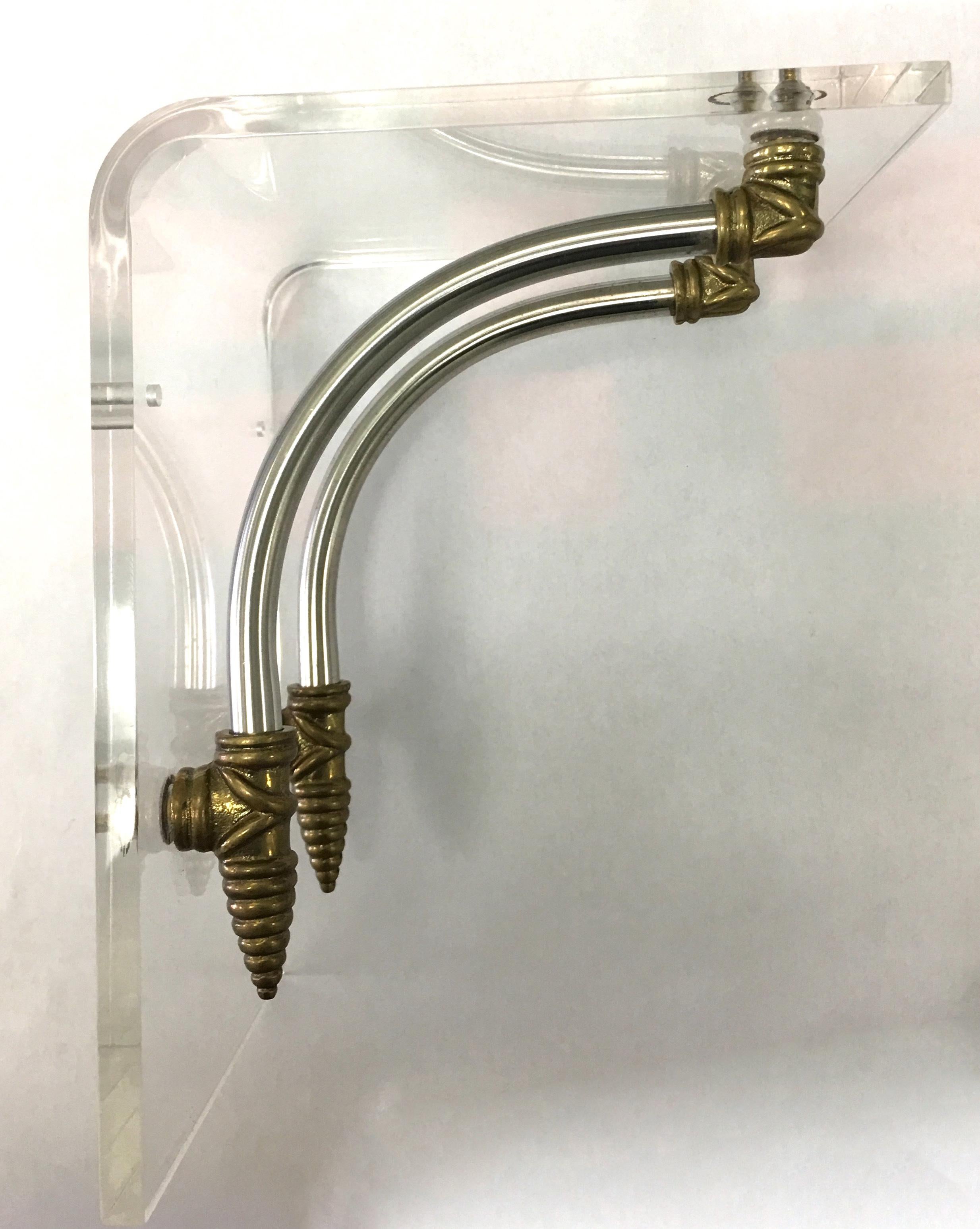 Pair of 1970s Hollywood Regency Lucite and brass wall brackets. Two pre drilled holes on the back. Priced per pair. Two pairs available.