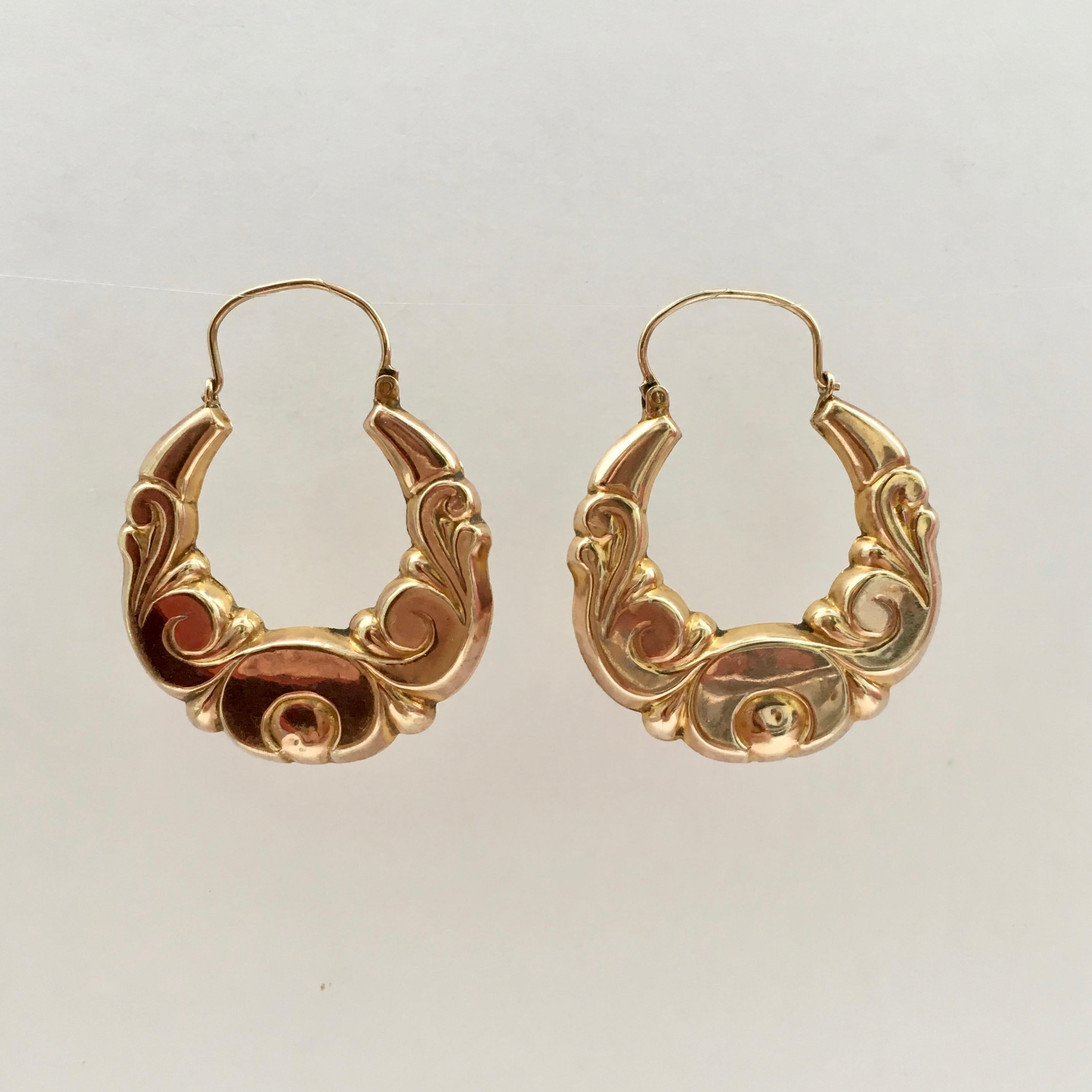 These vintage hoop earrings are particularly special with their unusual foliage swirls and desirable creole shape. The warm yellow gold is eye-catching and fashionable. They have full hallmarks on the top of each hook, which date them to 1973 and