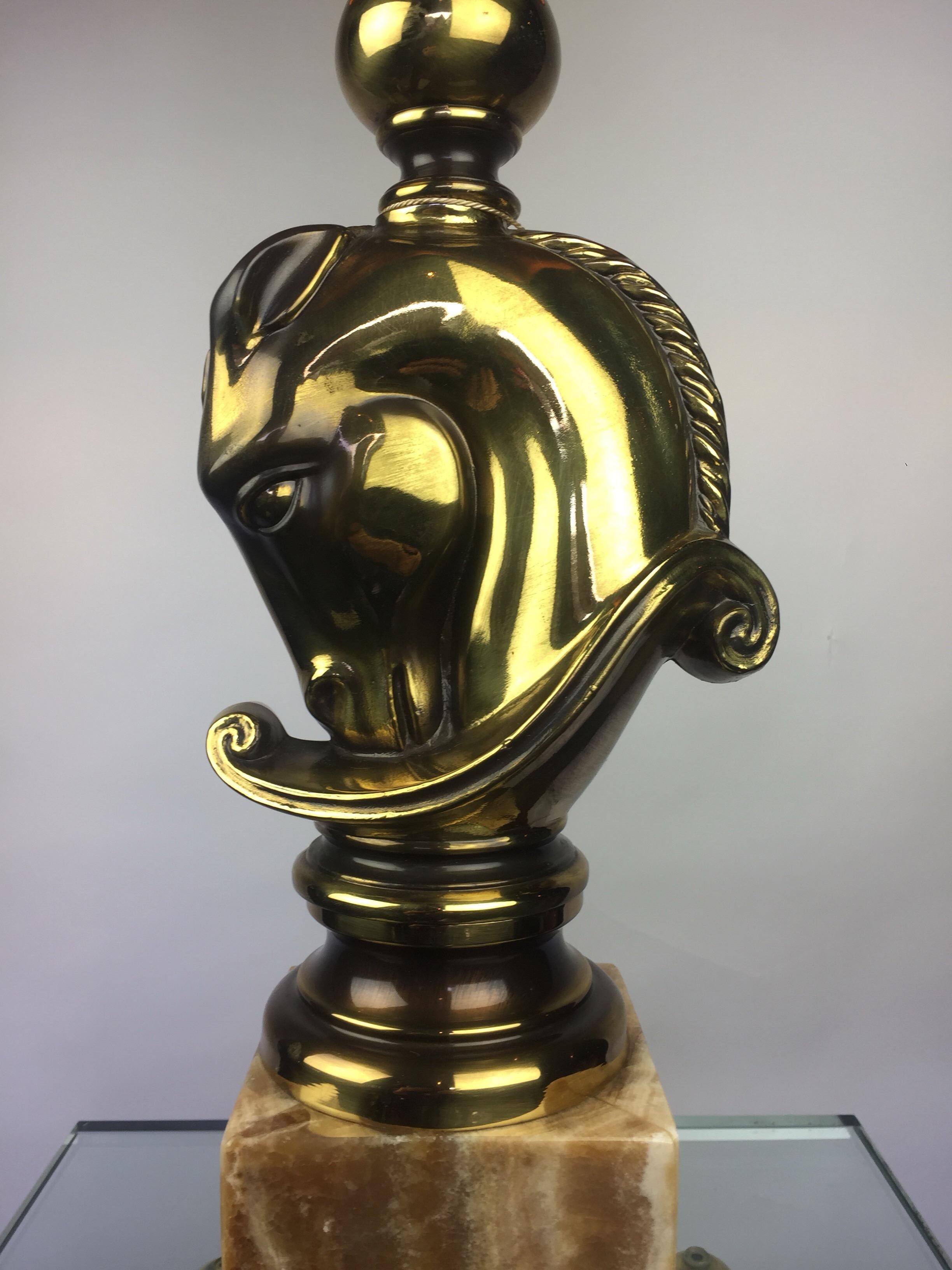 Elegant Hollywood Recency Style Horsehead Table lamp, 
Side Light , Table Lighting made by Deknudt Lustrerie, Belgium in the 1970s.
This Chess Piece Table Light by Maison Deknudt is made of bronze and brass metal horse on a brown Veined Onyx Base, a