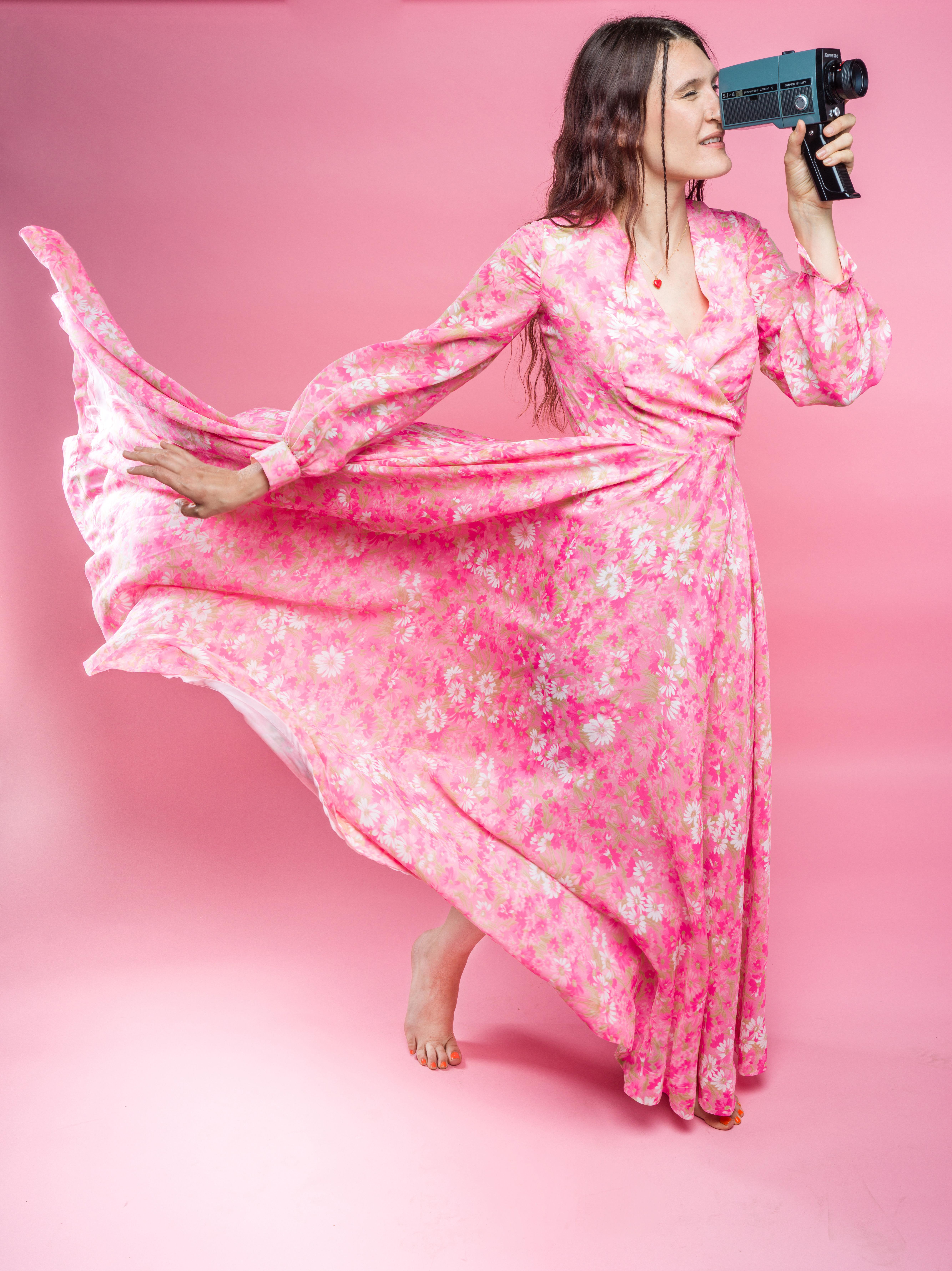 Incredible one of a kind 1970’s handmade hot pink & white floral full length, long sleeve maxi gown. This stunning piece features a very full flowing circle skirt that is gradually longer in the back, with lots of yardage to create a dramatic twirl!