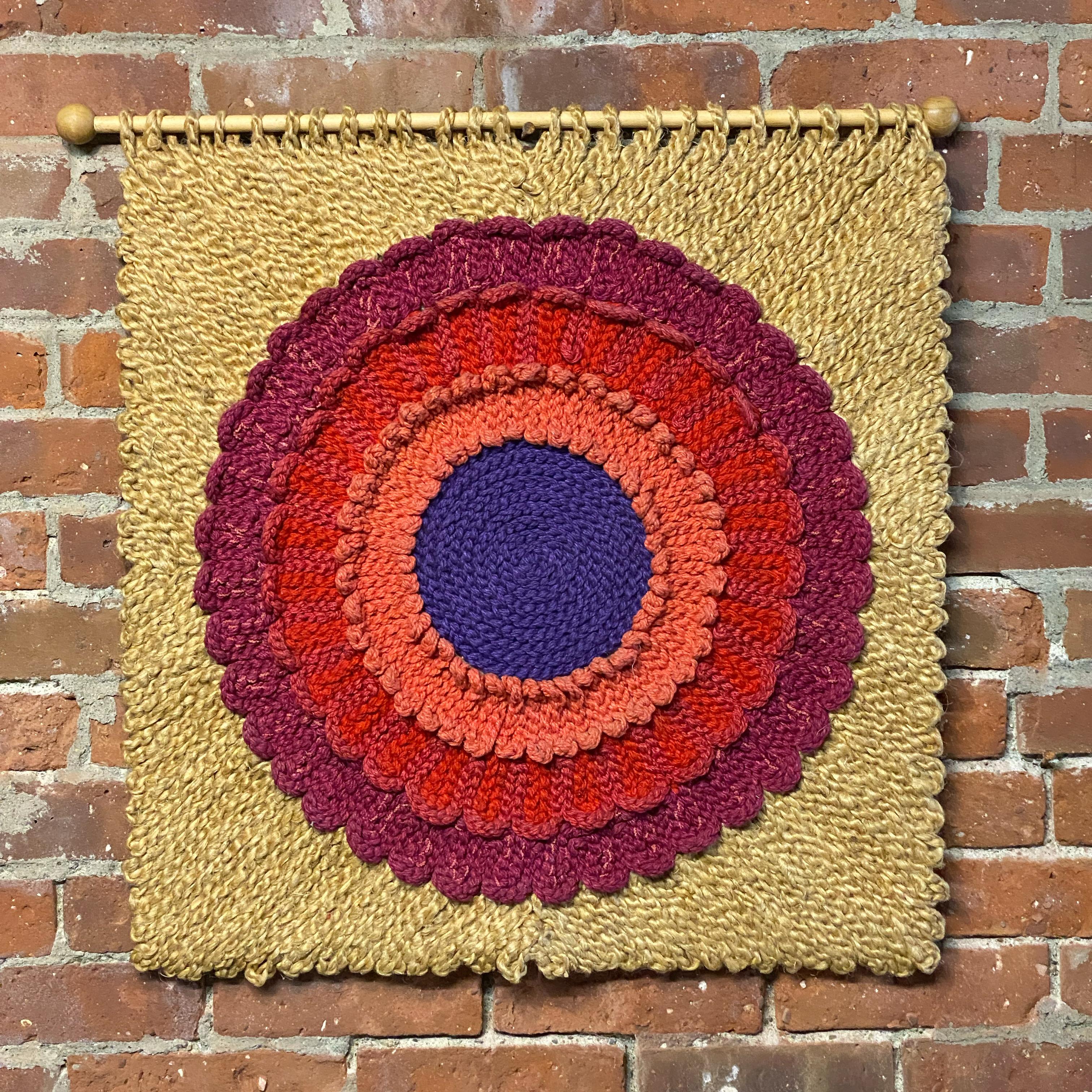 Vibrant and colorful floral fiber art wall hanging. Signed on the reverse, Szazsorszep, P. Szaboeva. Szazsorszep translates to daisy or golden daisy in Hungarian. The piece is comprised of a tan colored jute and what appears to be wool yarn in