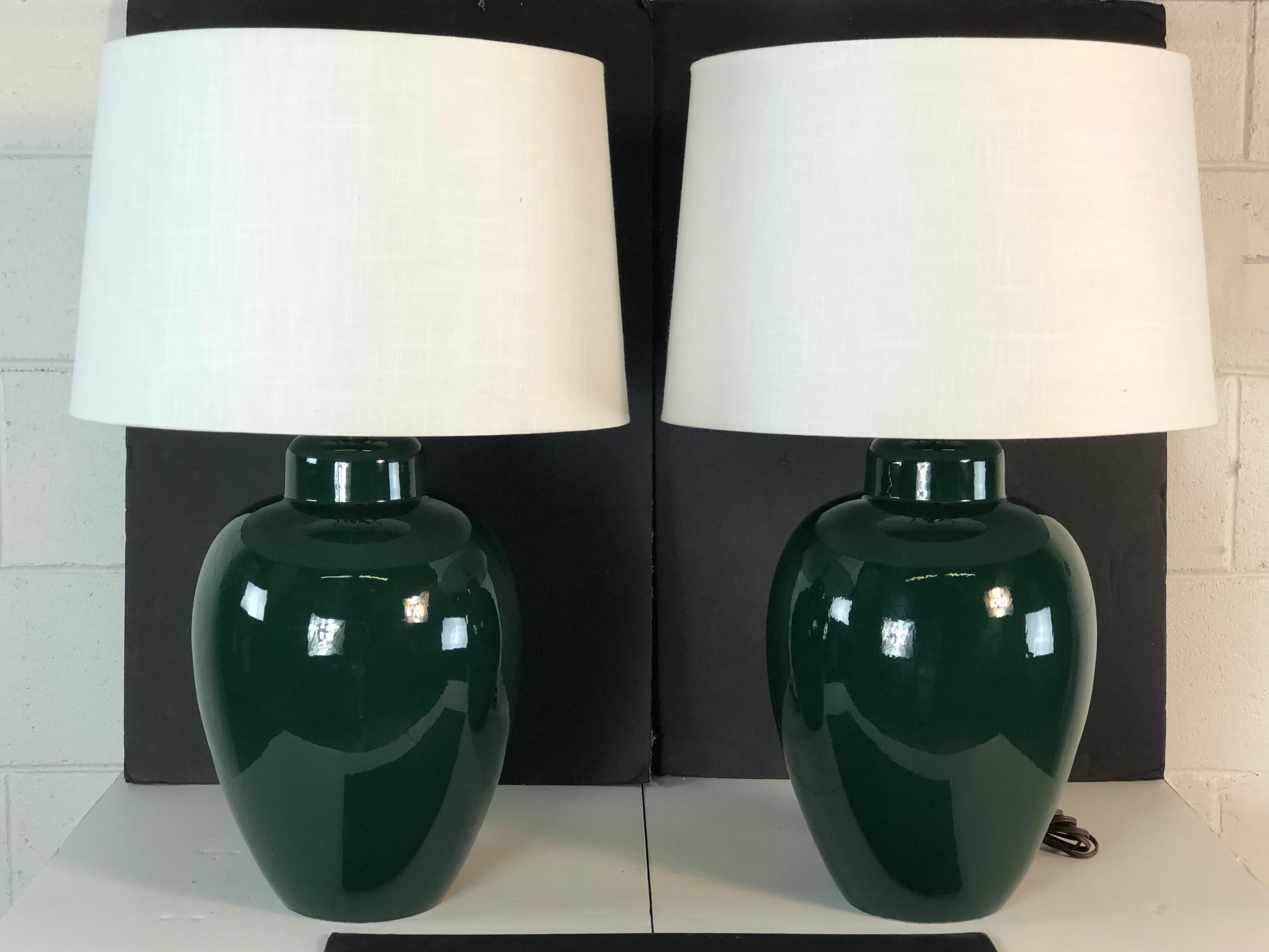 1970s pair of hunter green ceramic barrel table lamps. The lamps are wired for the US and in working condition. Socket, 18” height Harp, 4” diameter x 10” height. The lamp is marked Sunset Costco Inc. The shades are not included.