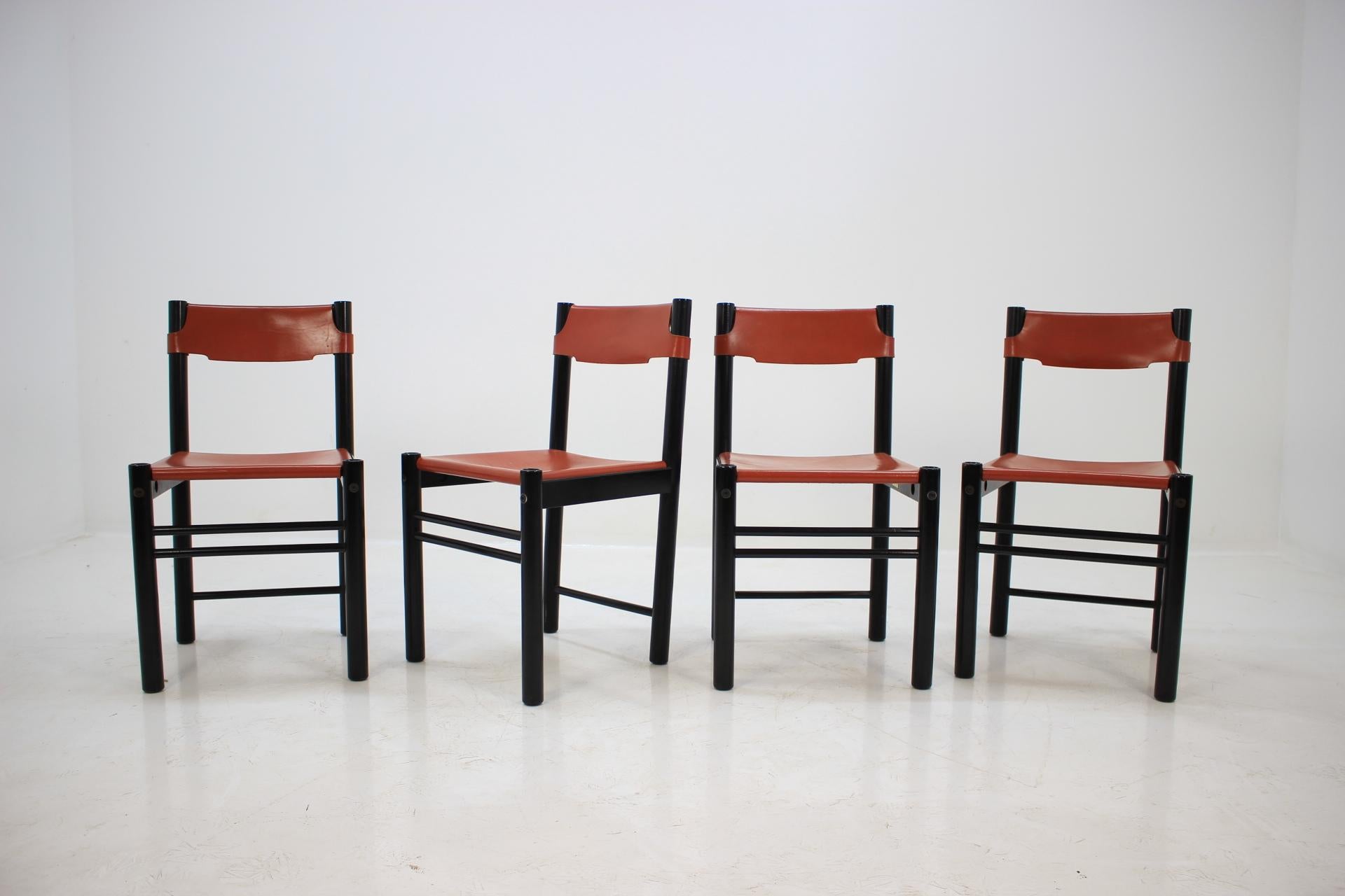 A set of four Italian leather on black wooden framed dining chairs. All are labeled from manufacturer. Good original condition.