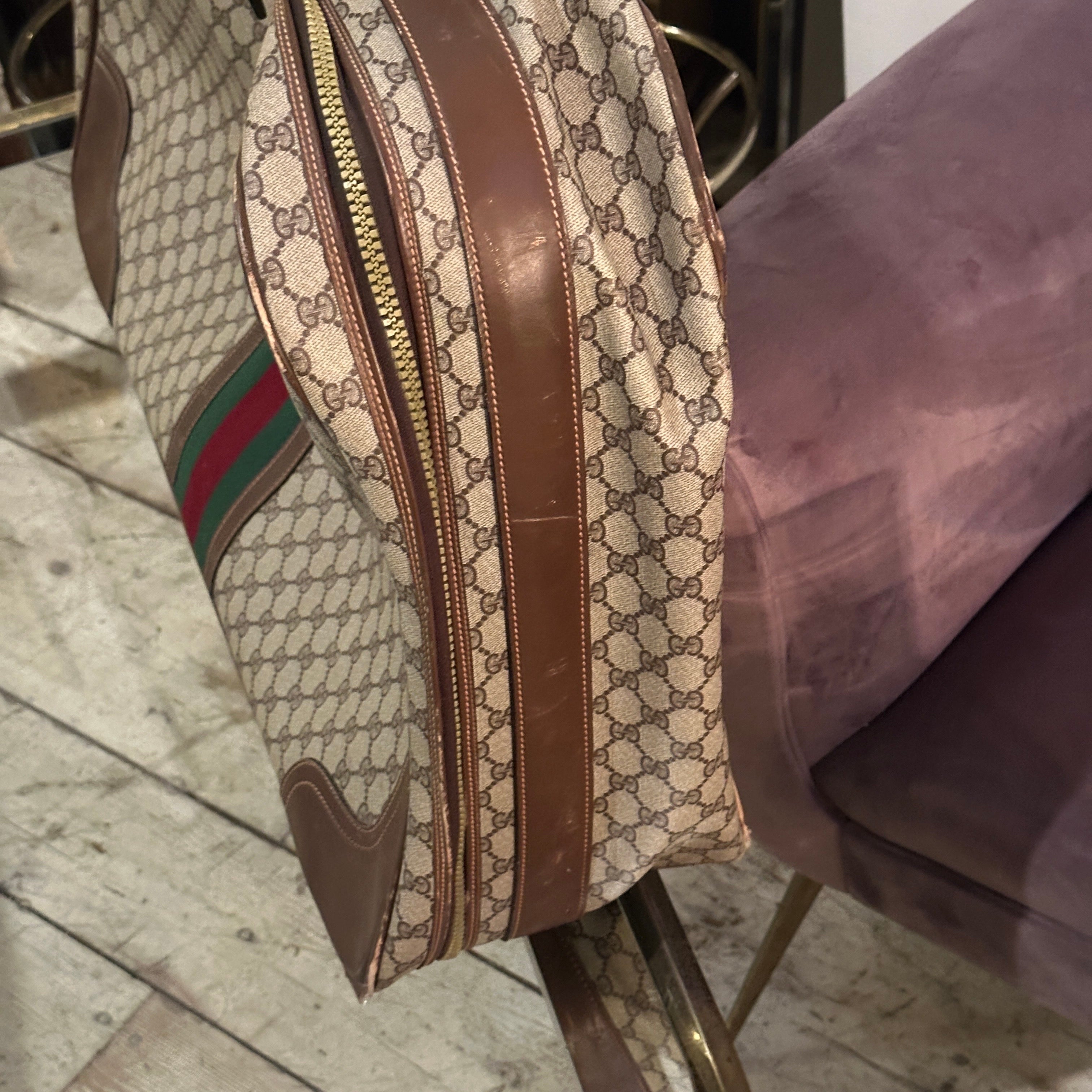 This **1970s Gucci suitcase** is the epitome of vintage luxury, showcasing the brand's unmistakable style and craftsmanship. Crafted in Gucci’s iconic beige and brown monogram canvas, the suitcase boasts a repeating **GG pattern** that instantly