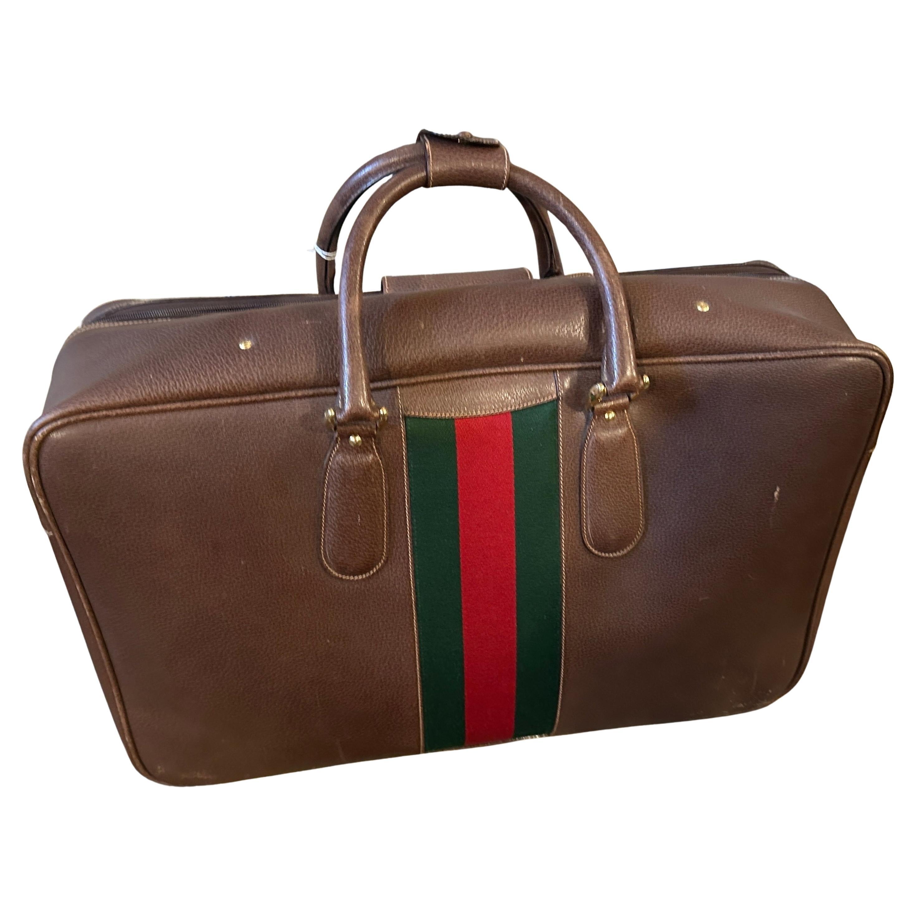 This authentic and beautifully preserved 1970s Gucci suitcase is a classic and highly sought-after piece.
Crafted in Italy, this suitcase is made from high-quality, rich brown leather that has aged gracefully, developing a unique and appealing