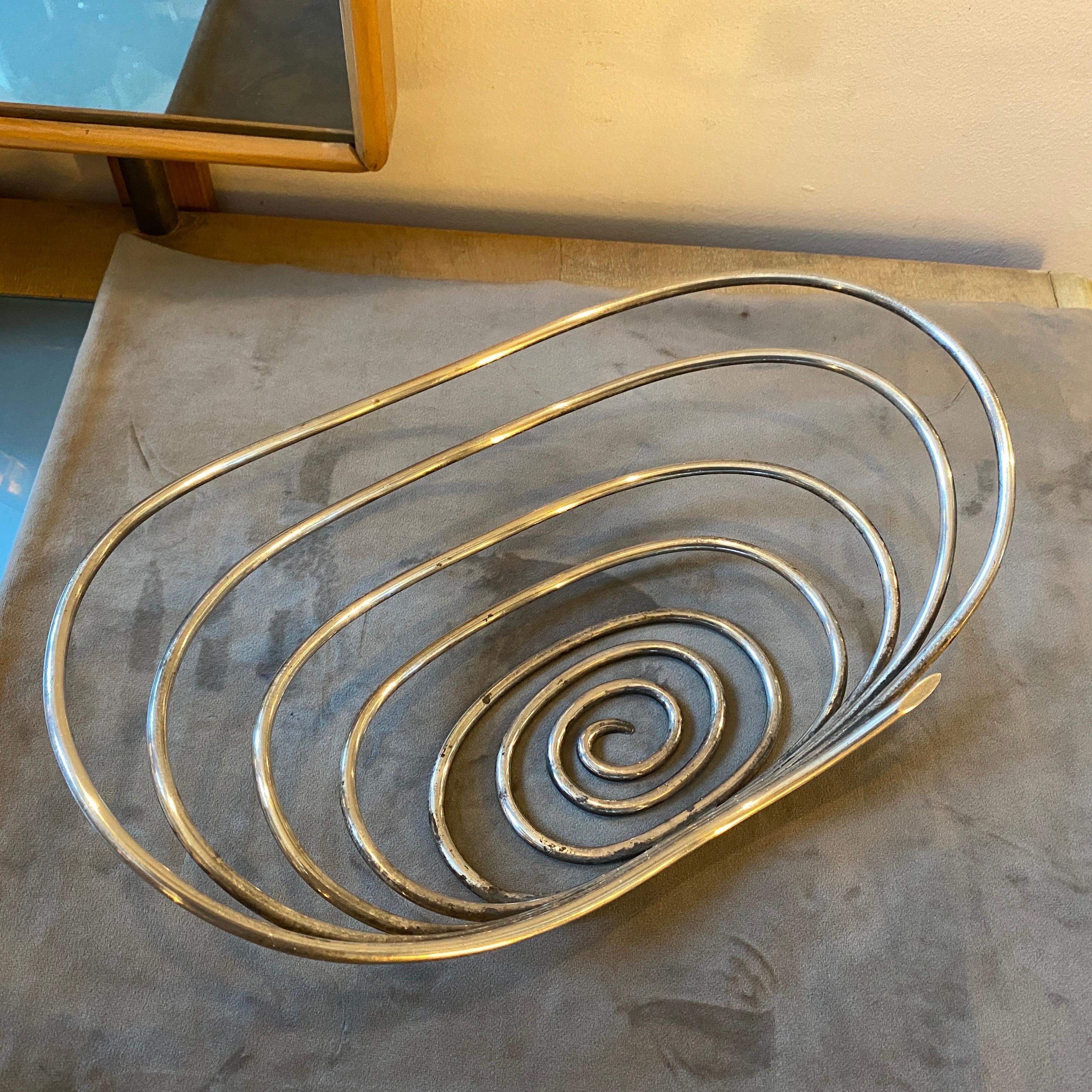 A stylish silver plated spiral bowl made in Italy in the Seventies by Sabattini argenteria. this piece it's in original patina, it can be easily cleaned. It's an iconic modernist piece of the italian designer Lino Sabattini. This spiral basket is a