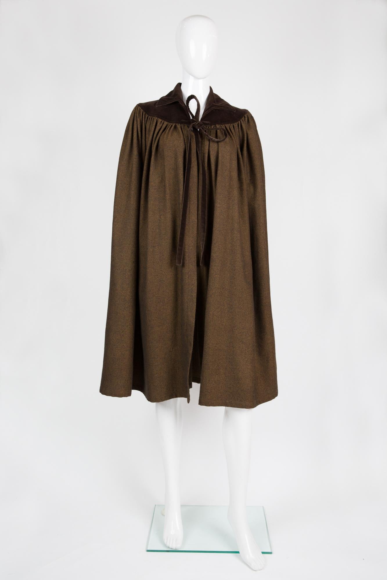 Iconic 1970 Yves Saint Laurent brown wool and velvet cape coat featuring a top shoulder brown velvet yoke, a front tie.
In good vintage condition. Made in France. (small restorations have been nicely done)
Estimated size 36fr/ US4/ UK8
Label size