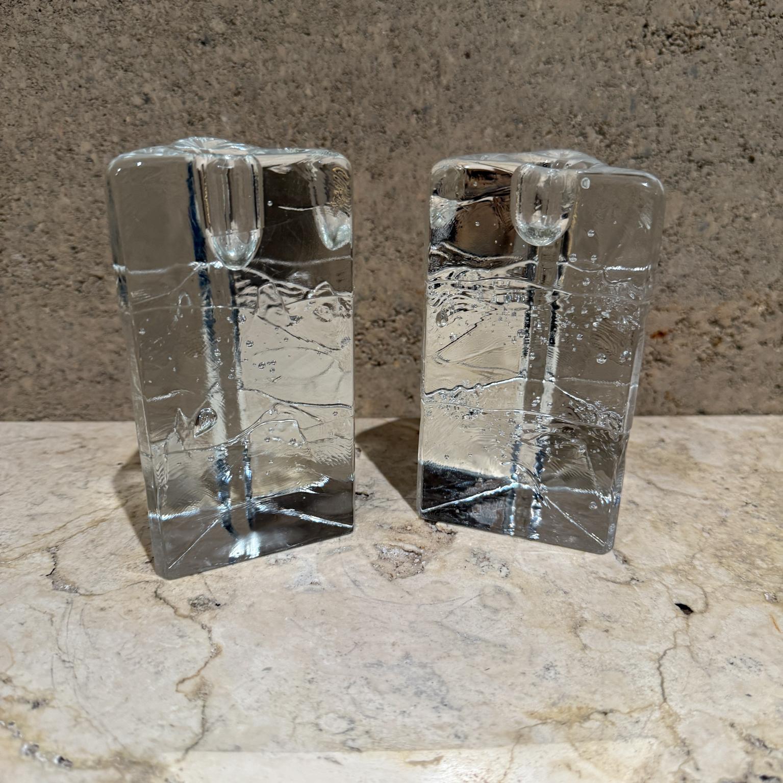 1970s Arkipelago glass candle holders Timo Sarpaneva Iittala Finland.
Triangular cast glass candle holders are from the Arkipelago line 
designed by Timo Sarpaneva produced by Finnish company Iittala. 
Designed to resemble Nordic ice with appearance