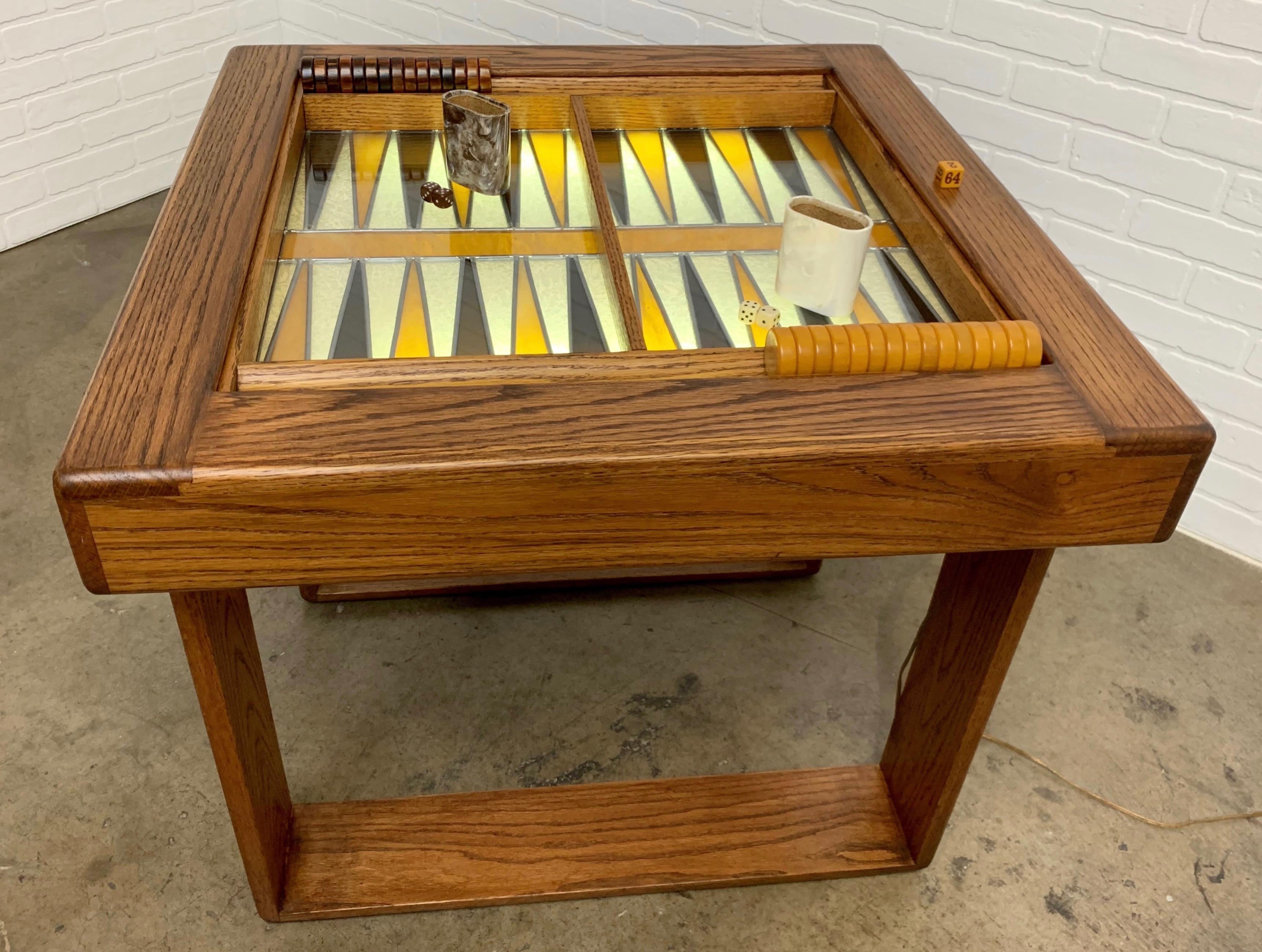 Modernist solid oak table in the style of Lou Hodges with lap joint and dowel construction and leaded glass backgammon board.
The glass surface is back lit for ambiance. Crisloid vintage game pieces included.