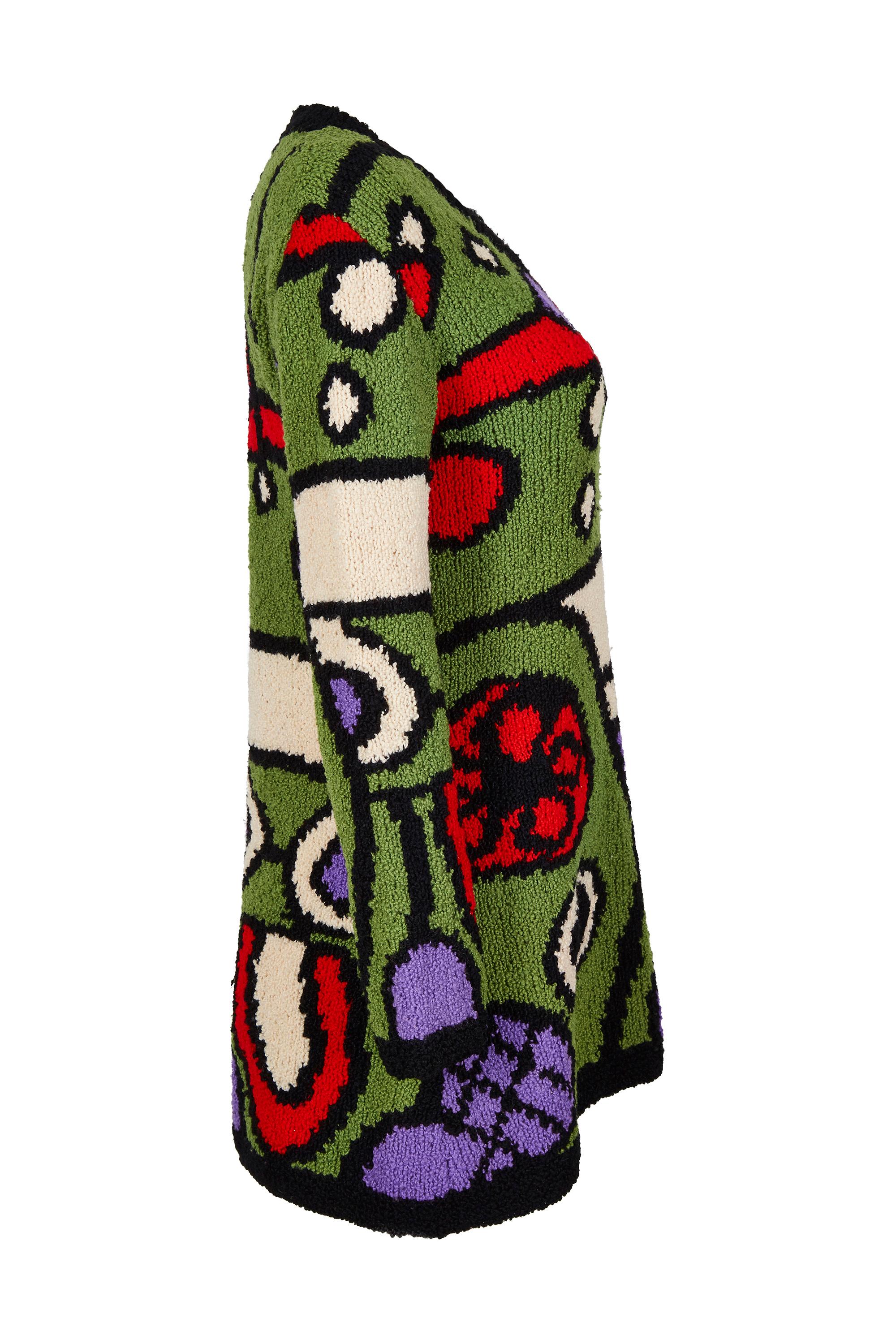 Dieser handgestrickte Wollpullover aus den 1970er Jahren mit seinem auffälligen mehrfarbigen Muster wurde von dem berühmten amerikanischen Luxuskaufhaus I.Magnin vertrieben, einem Unternehmen, das dafür bekannt war, nur die hochwertigsten Waren