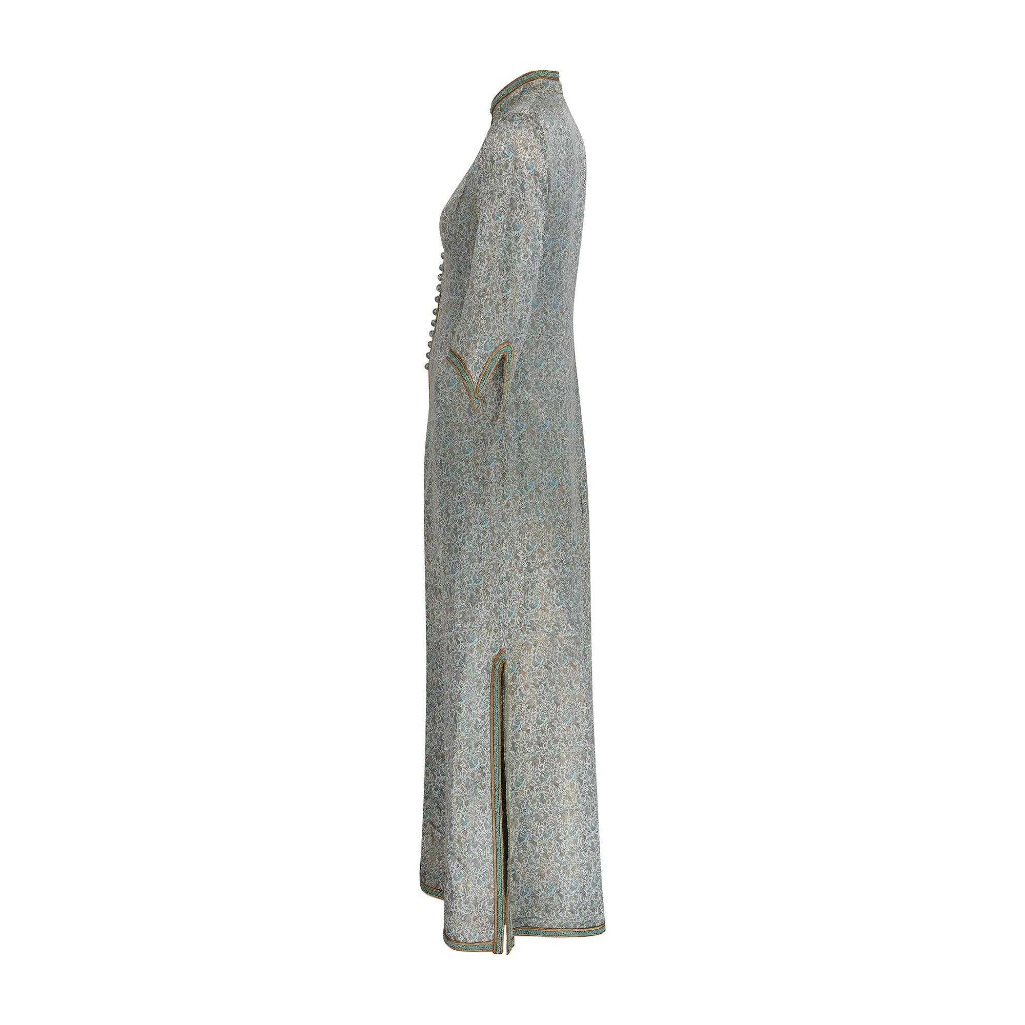 This magnificent 1970s coat dress was likely bespoke made and came from the wardrobe of a titled socialite along with some other fabulous couture garments. It is crafted from the finest Indian woven silk brocade, patterned with elephants, peacocks,