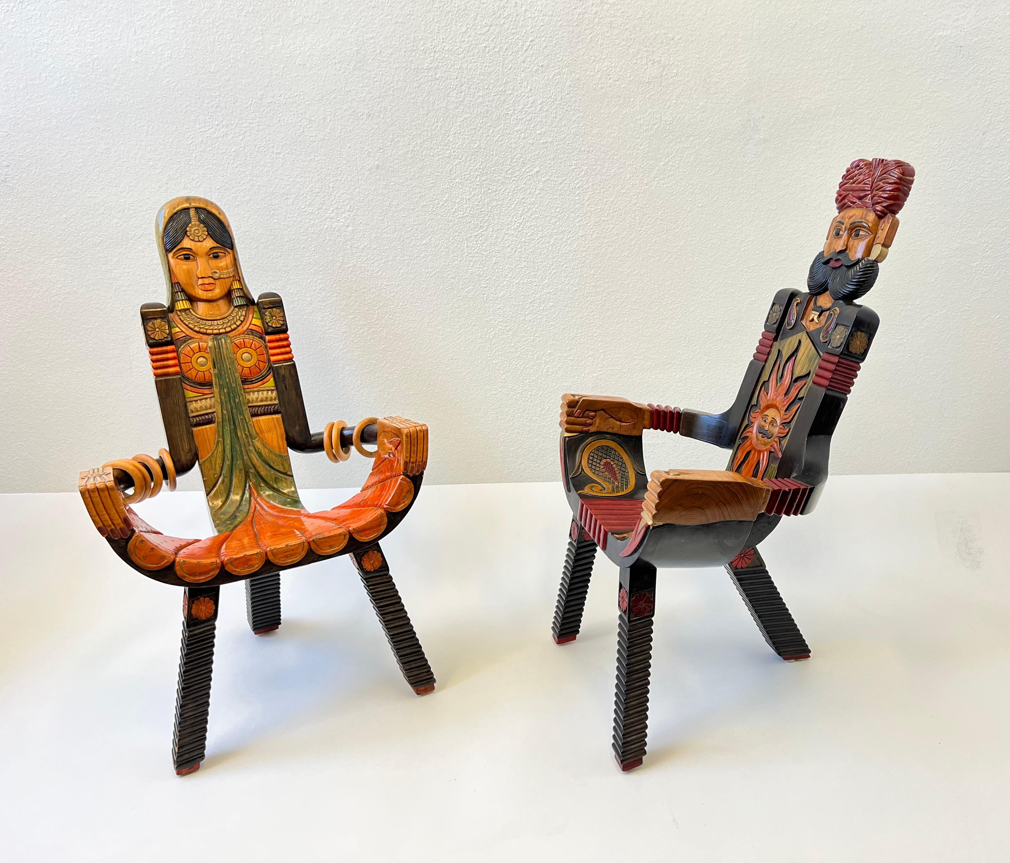 Pair of Indian hand carved and painted wood male and female chairs. 
This were purchased in India in the 1970’s.
In beautiful original condition.
Measurements: 21.5” Deep, 21” Wide, 34.75” High, 13.75” Seat.