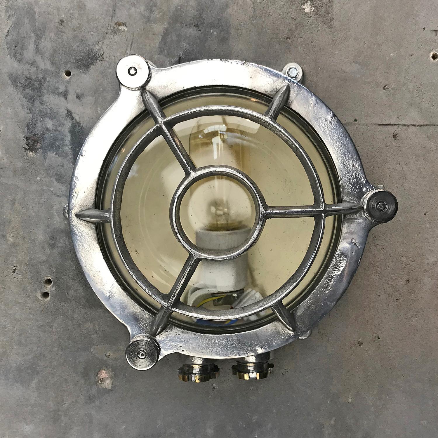 A classic maritime Industrial design, this type of aluminium circular bulkhead is found on ships passageways.

Solid cast aluminium construction with tempered glass dome, and fitted with CE certified ceramic E27 lamp