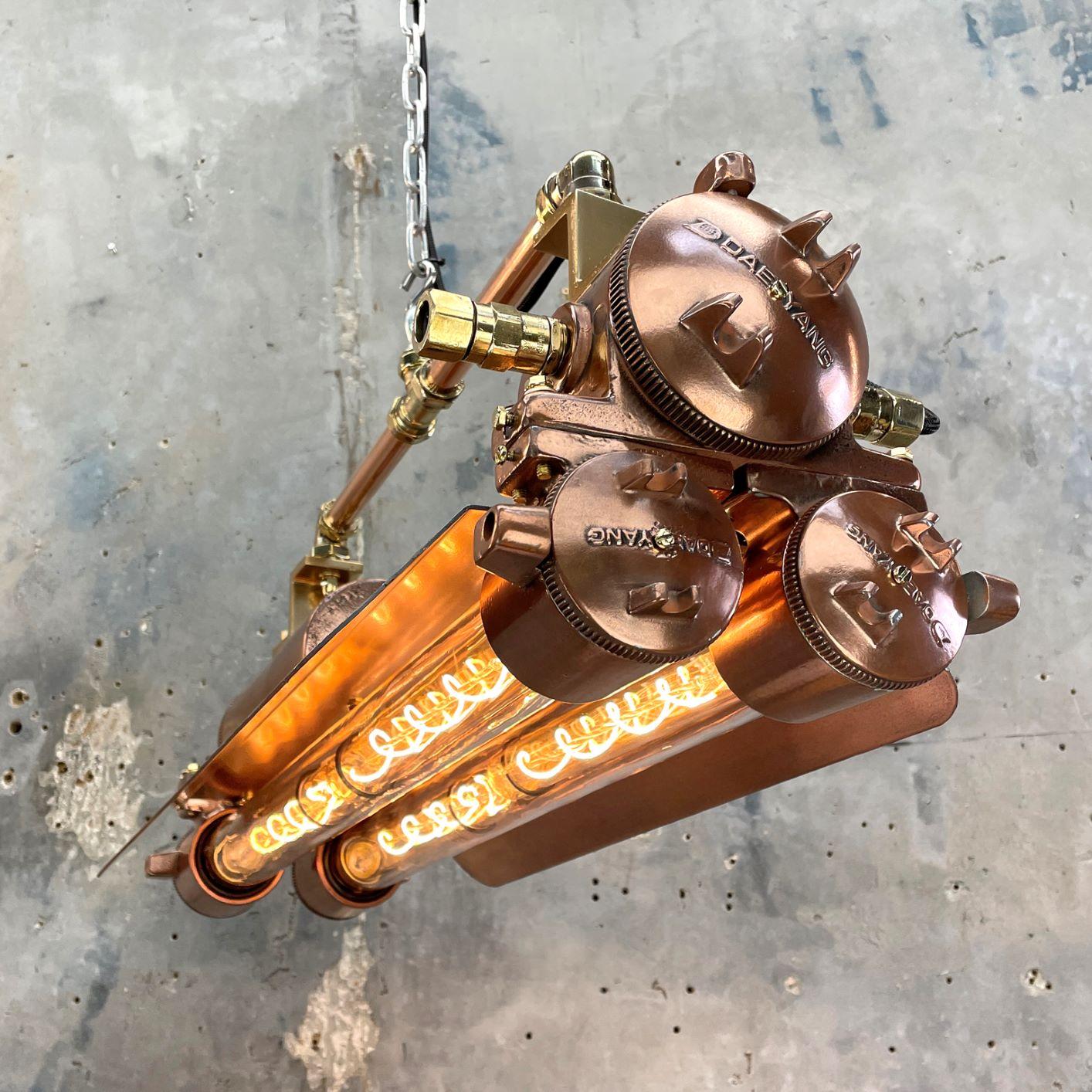 1970s vintage industrial copper and brass flameproof LED tube ceiling strip light made by Daeyang with adjustable suspension bar.
 
Original item salvaged from decommissioned ships then professionally restored in-house in the UK to modern lighting