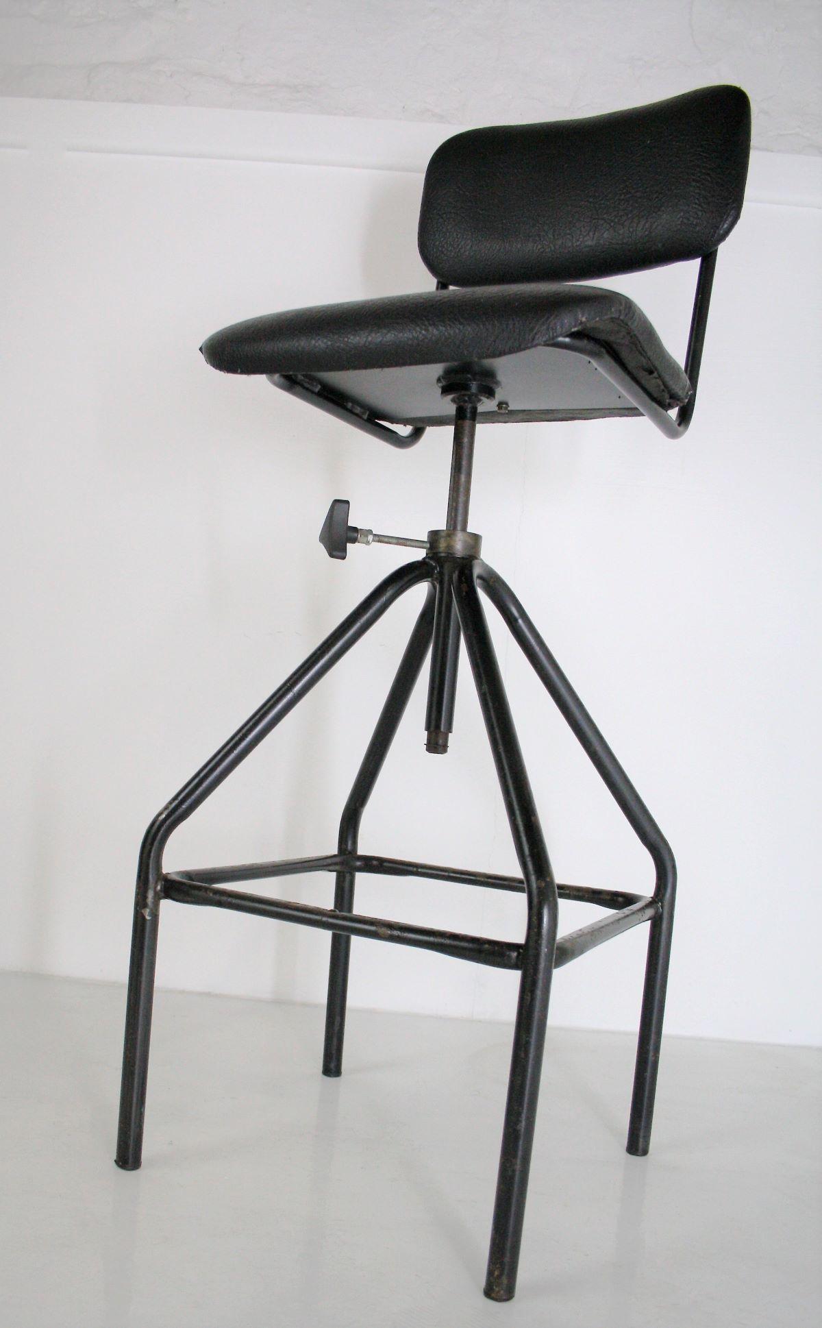 A nice industrial 1970's Swivel Stool, great shape with strong lines.  The black paint is chipped and worn giving it a great look and feel.
The vinyl leather grain effect seat has a few small areas of wear as photographed but is in good sound