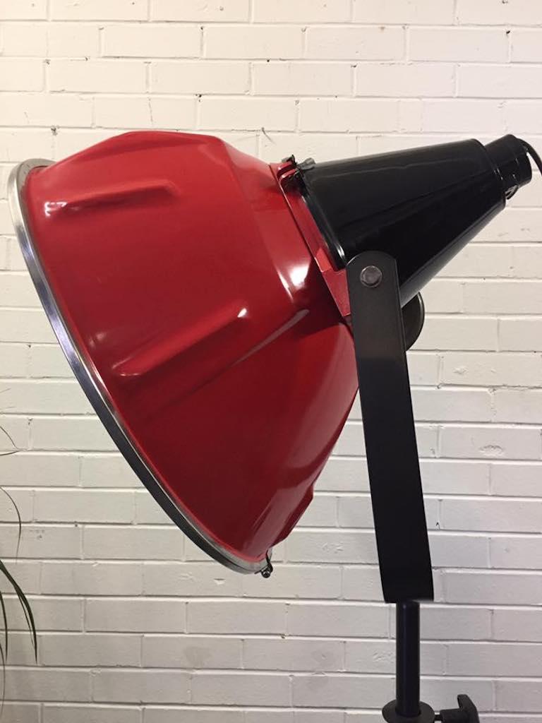 This striking industrial film floor light is a statement piece. 

The stylish iron tripod base works perfectly with the distressed metal lamp design.

Entirely refurbished, while keeping it's original look completely intact.
Disassembled, stripped,