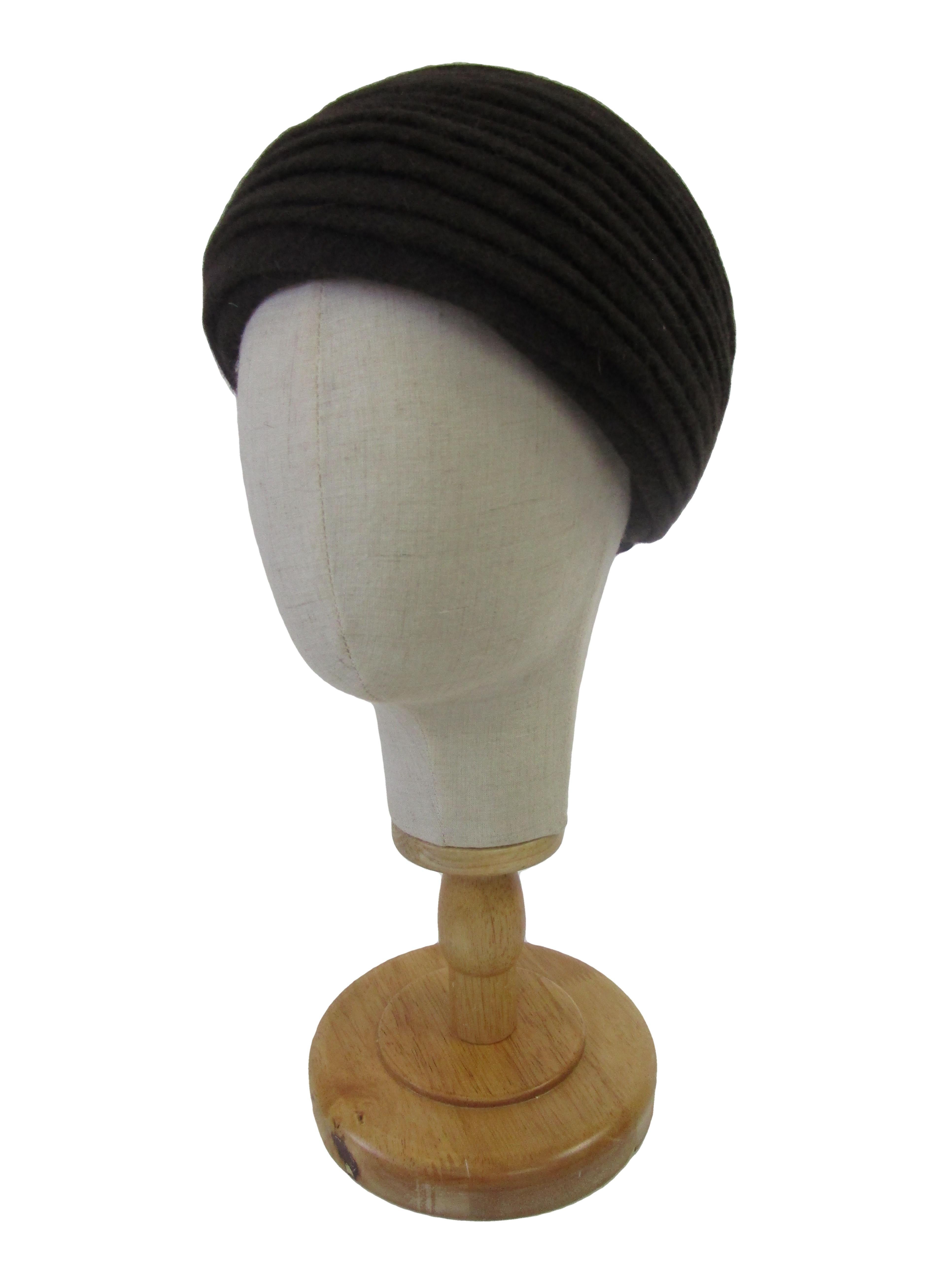 

Classic styled turban from Irene of New York!  This turban features a soft knitted fabric perfect for the fall and winter time. Hand stitched detailing and craftsmanship is found throughout with its folds that are tacked down by long strands of
