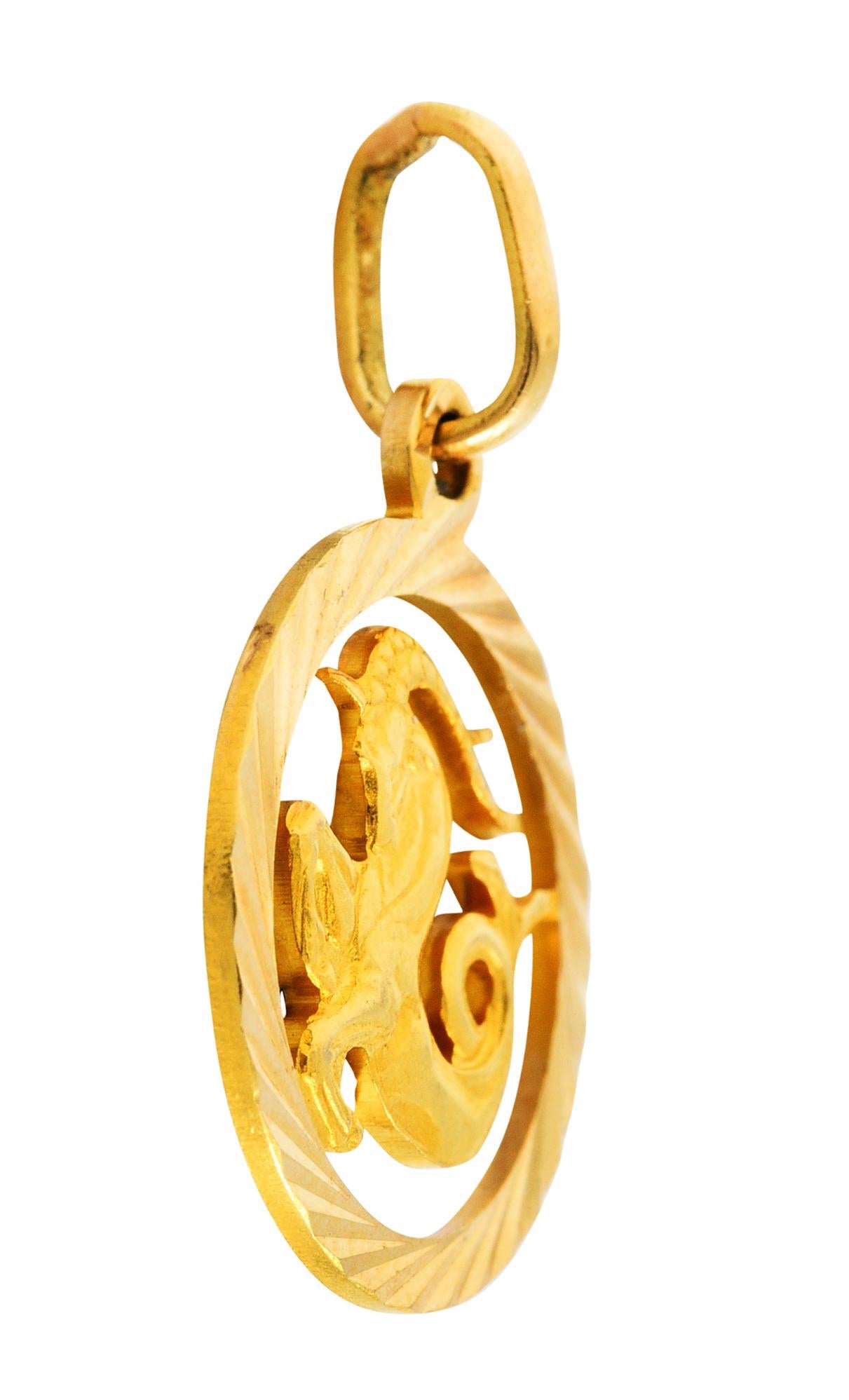 Designed as a pierced open circle with a deeply faceted surround

Centering a highly rendered image of a nautical ram 

With a scrolling finned tail and elongated horns

With Italian assay marks for 18 karat gold

Circa: 1970s

Measures: 11/16 x 1