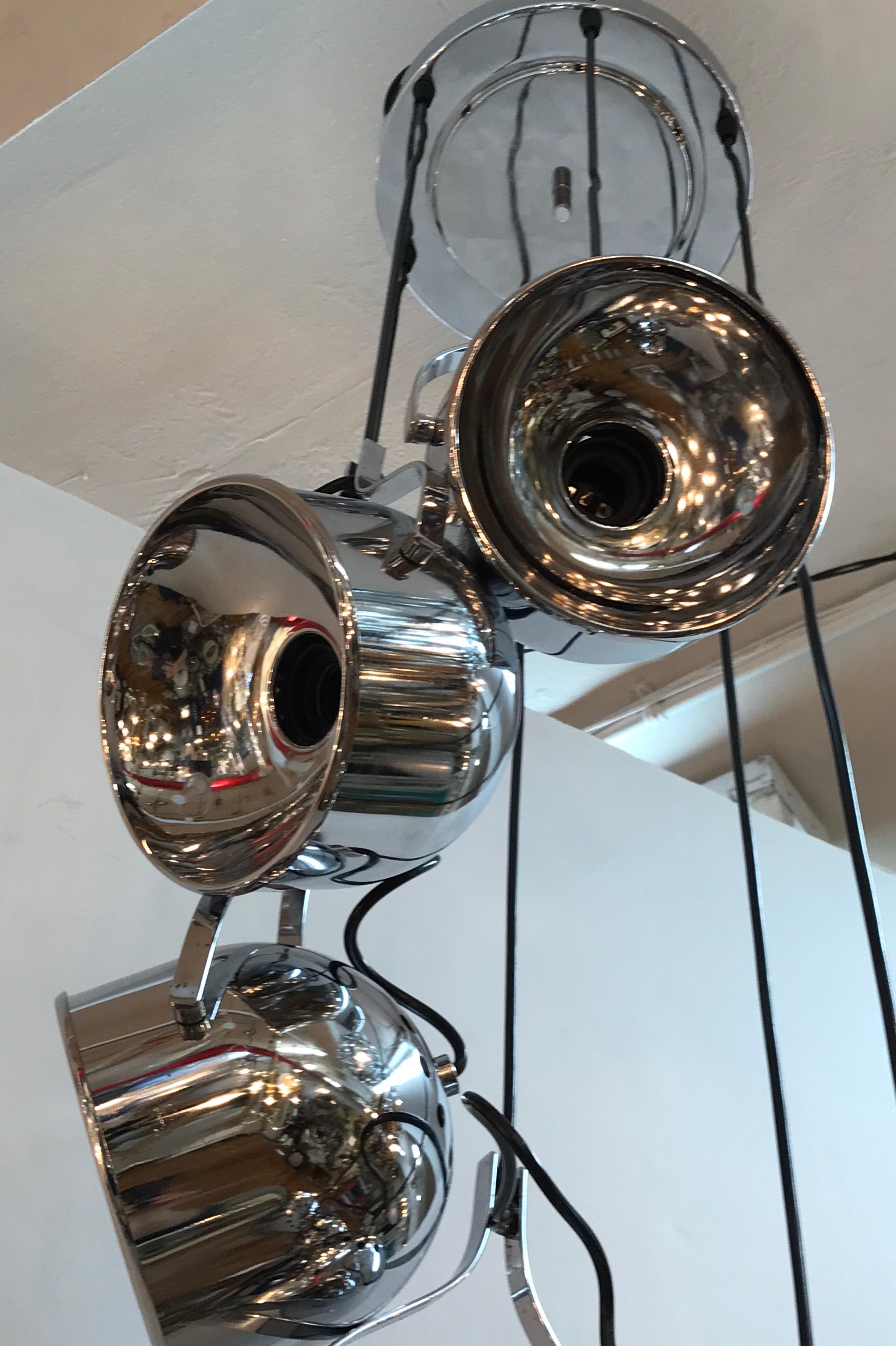 A wonderful architectural and statement piece pendant light fixture from Italy, circa 1970. Each of the six domed canisters may be angled individually and require one standard light bulb. The canisters are suspended from the original matching chrome