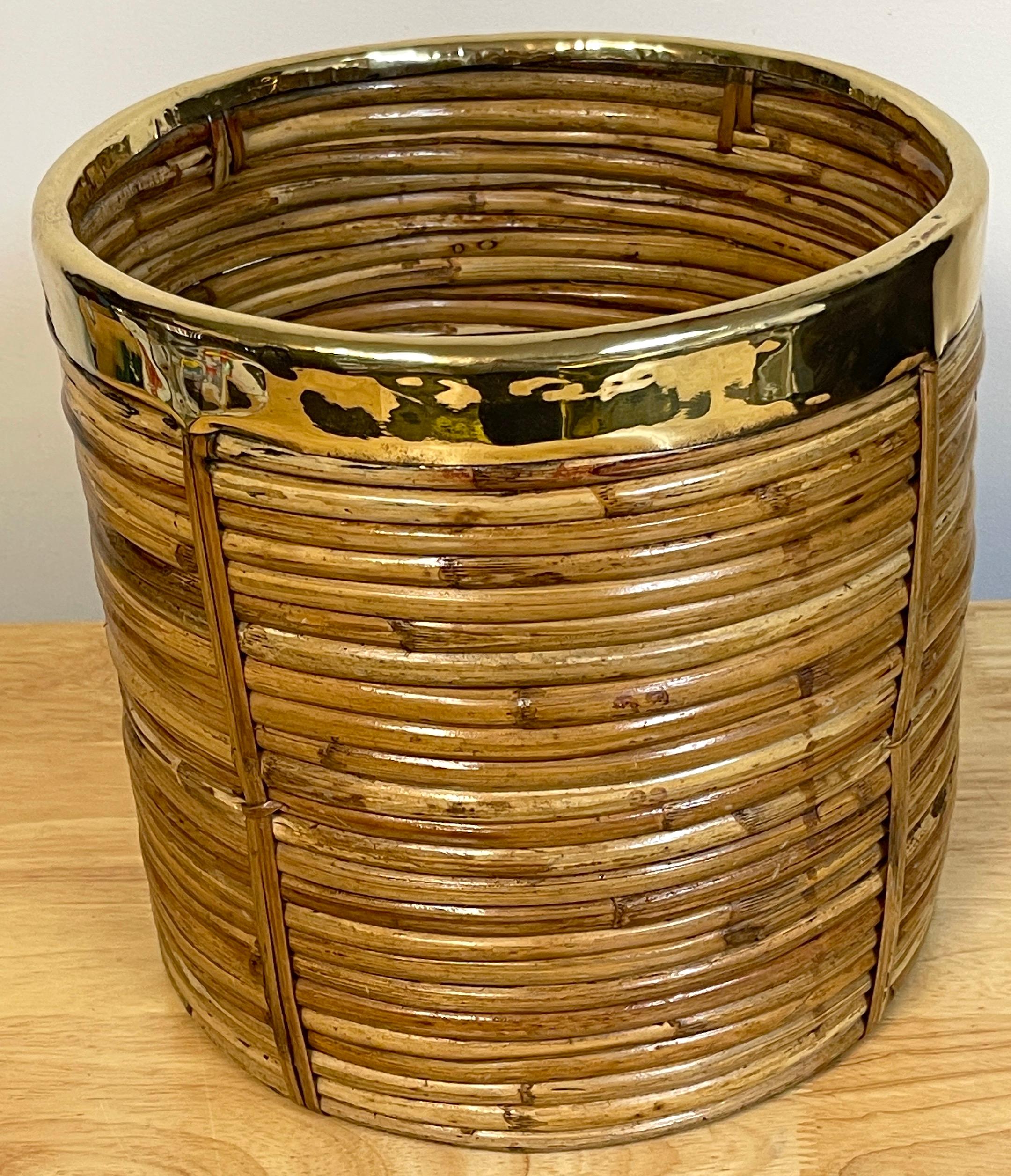 1970s Italian bamboo/ rattan wastepaper basket with polished brass rim
Mid-Century Modern decorative bamboo, rattan and brass Wastepaper basket. basket. Handcrafted in Italy, 1970s. Round in shape with professionally polished brass rim. Inspired on