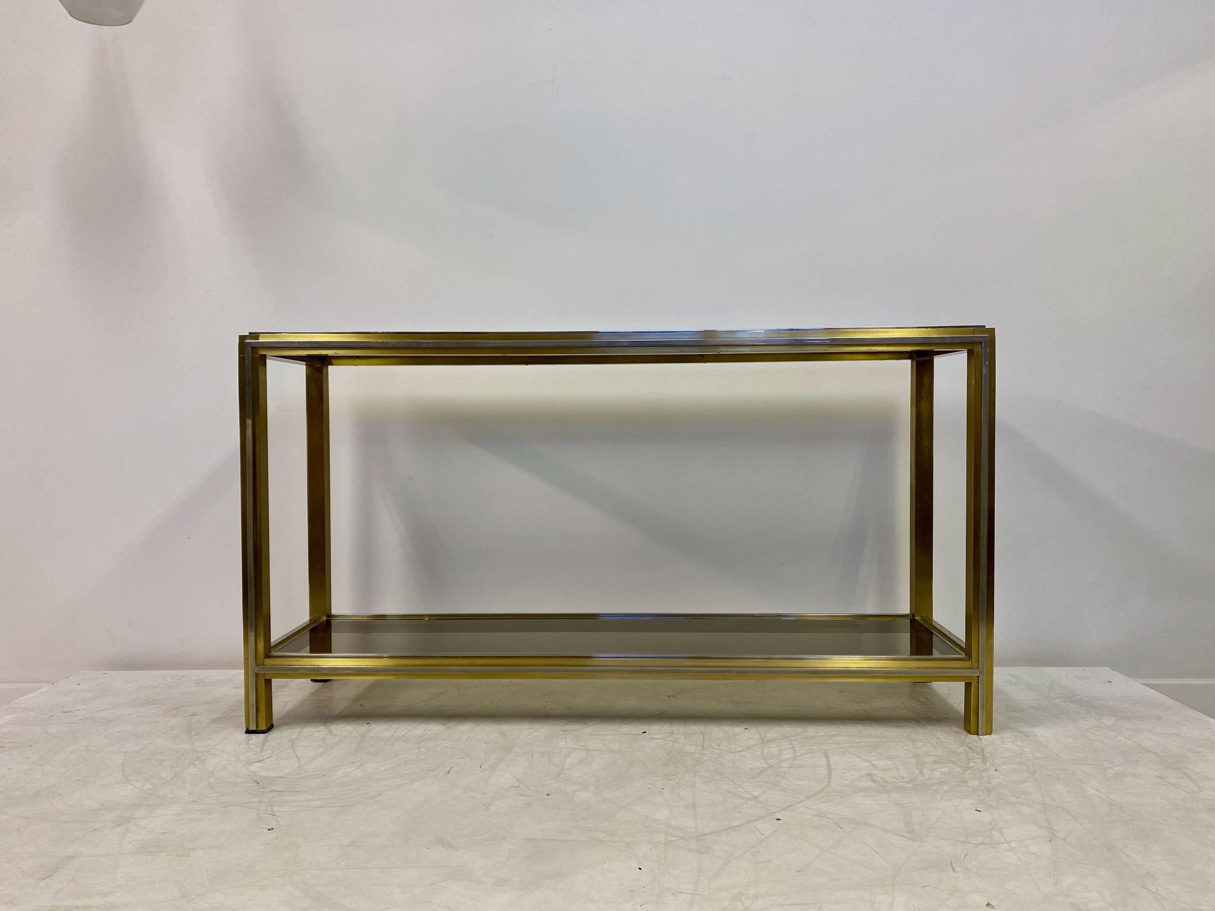 Console table

By Romeo Rega

Brass and chrome protruding bands

Excellent quality version of this type of table

Currently with original smoked glass but will be changed to toughened before sale. 

Clear glass can be chosen instead of