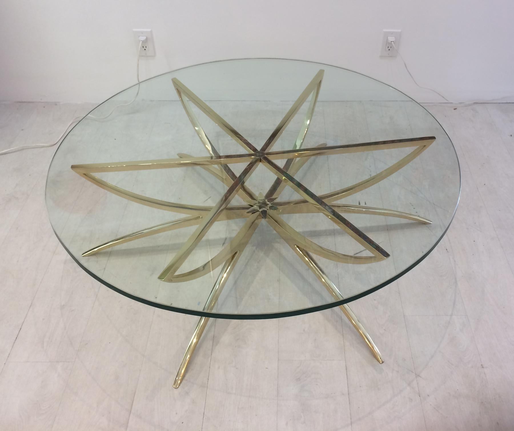 In the style of Carlo de Carli solid brass coffee table. Base has been polished and lacquered. Has a ¾ inch glass top is in very good condition. Looks stunning and is in ready to place in your home
48 inch diameter top. Though this table has a